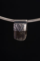 Himalayan Dravite Tourmaline Stack Pendant shown on black background with oxidized 925 silver cap and dark crystal body.