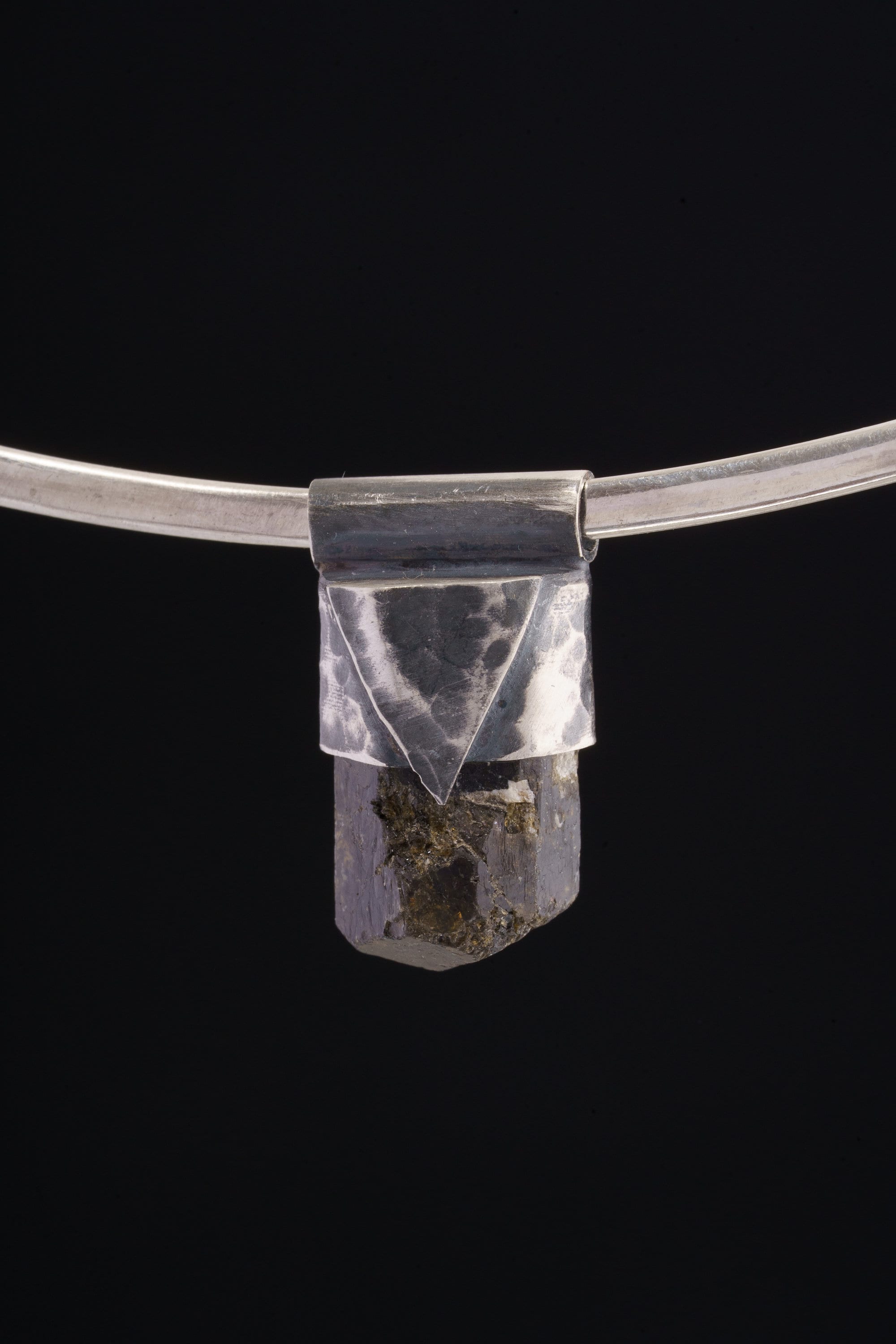 Himalayan Dravite Tourmaline Stack Pendant shown on black background with oxidized sterling silver cap and dark terminated crystal.