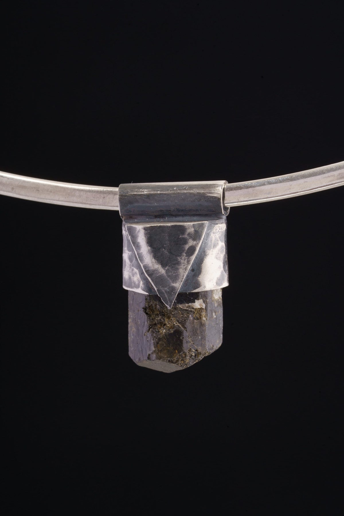 Himalayan Dravite Tourmaline Stack Pendant shown on black background with oxidized sterling silver cap and dark terminated crystal.
