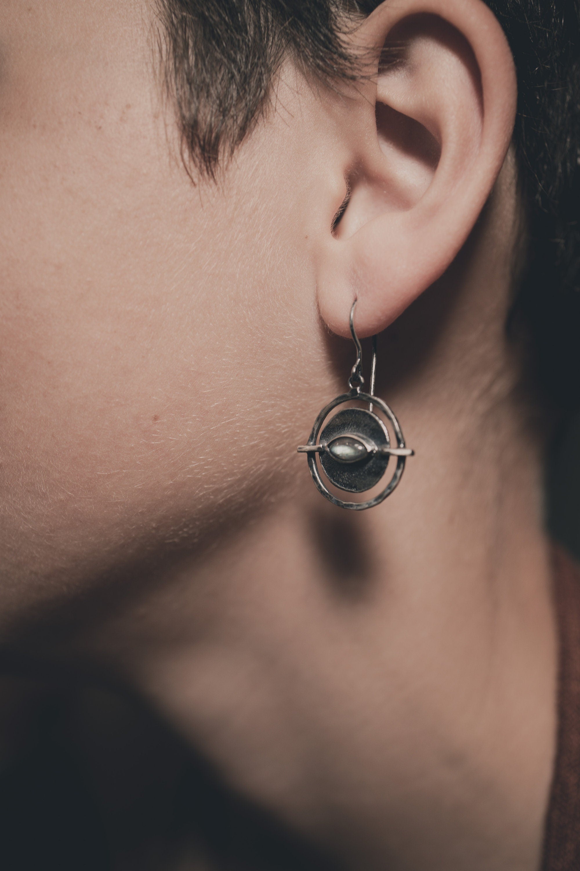 Old World Labradorite Circle earring shown worn on a model, highlighting the portal-style silver frame.