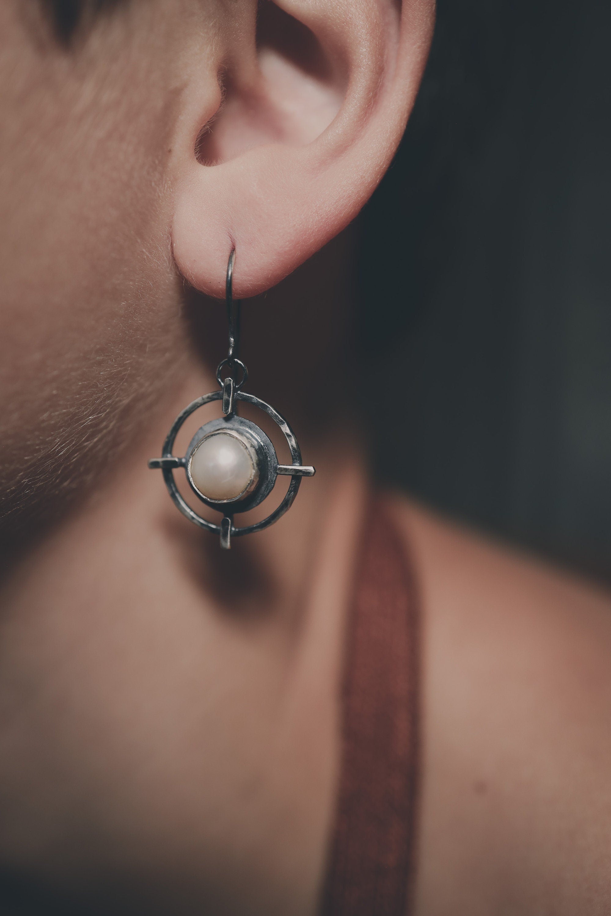 South Sea Pearl statement earring shown on a model, highlighting layered silver geometry and old-world talisman style.