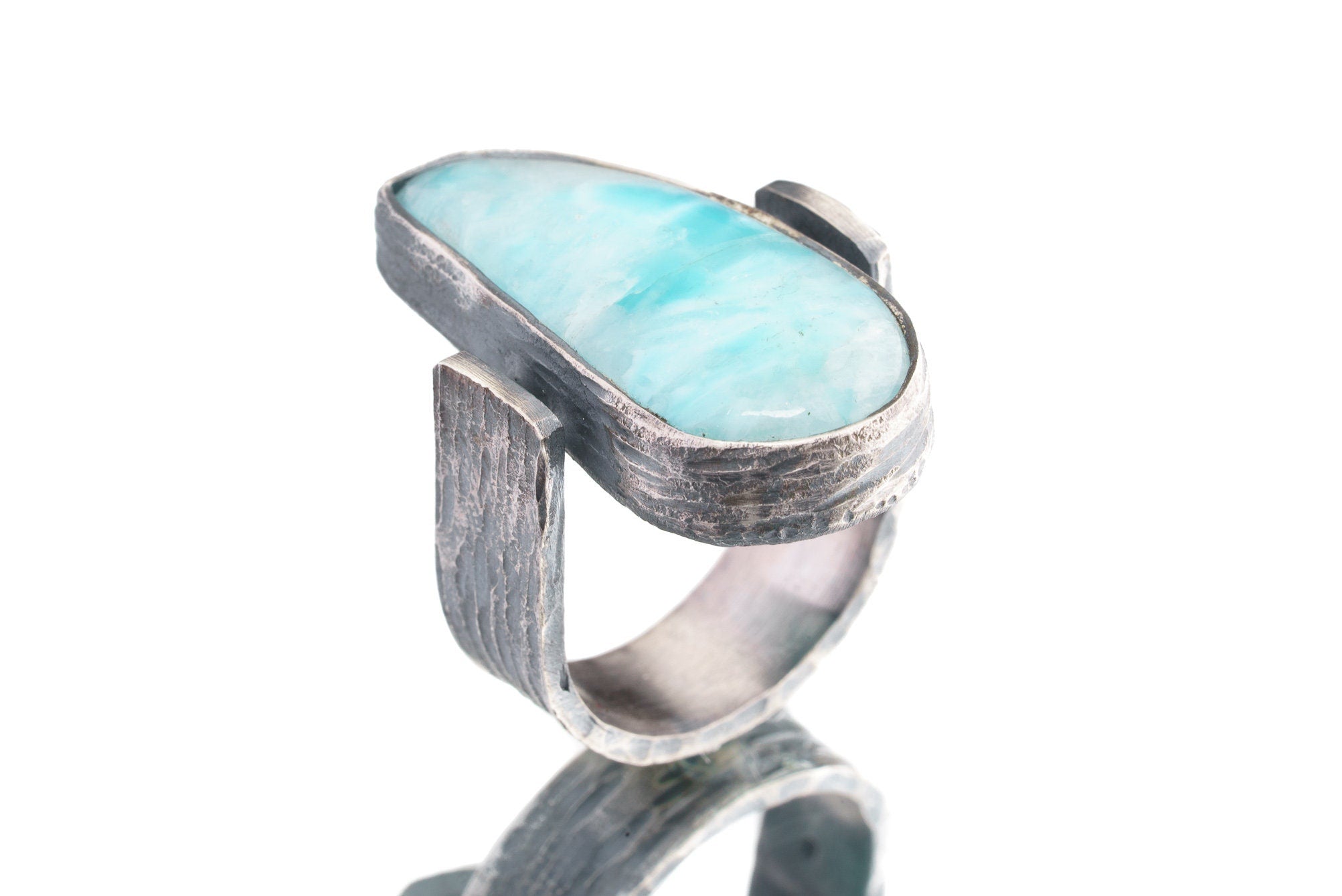 Side view of Larimar ring showing rock-hammered oxidized sterling silver, raised bezel setting, and strong profile.