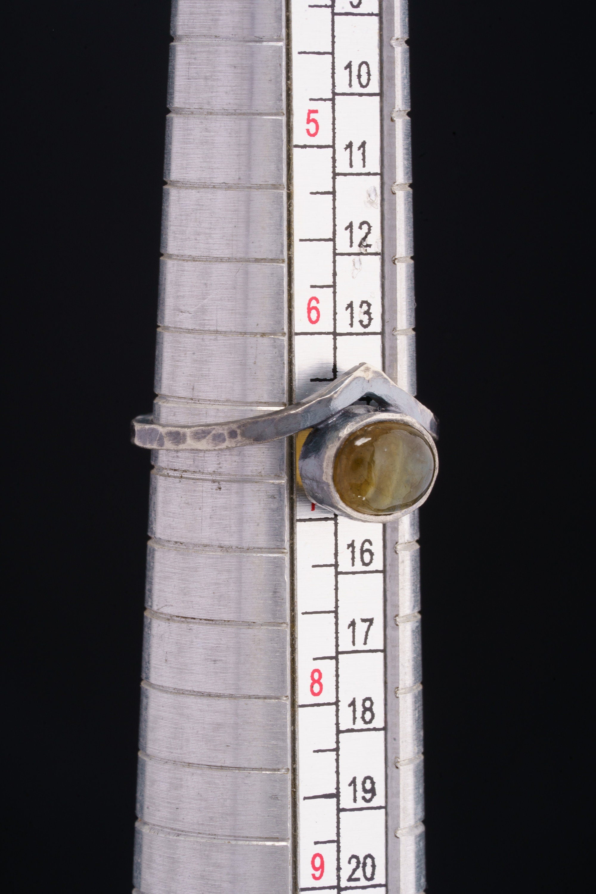 Golden Rainbow Labradorite Band Ring shown beside a ruler for scale with slim solid sterling silver band.