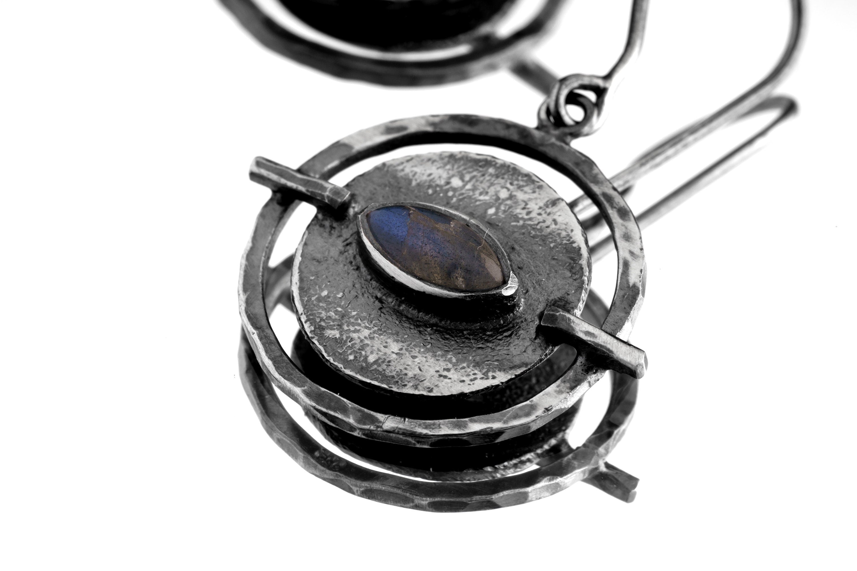 Close-up of Labradorite Circle earring showing hammered silver texture and bezel-set gemstone flash.