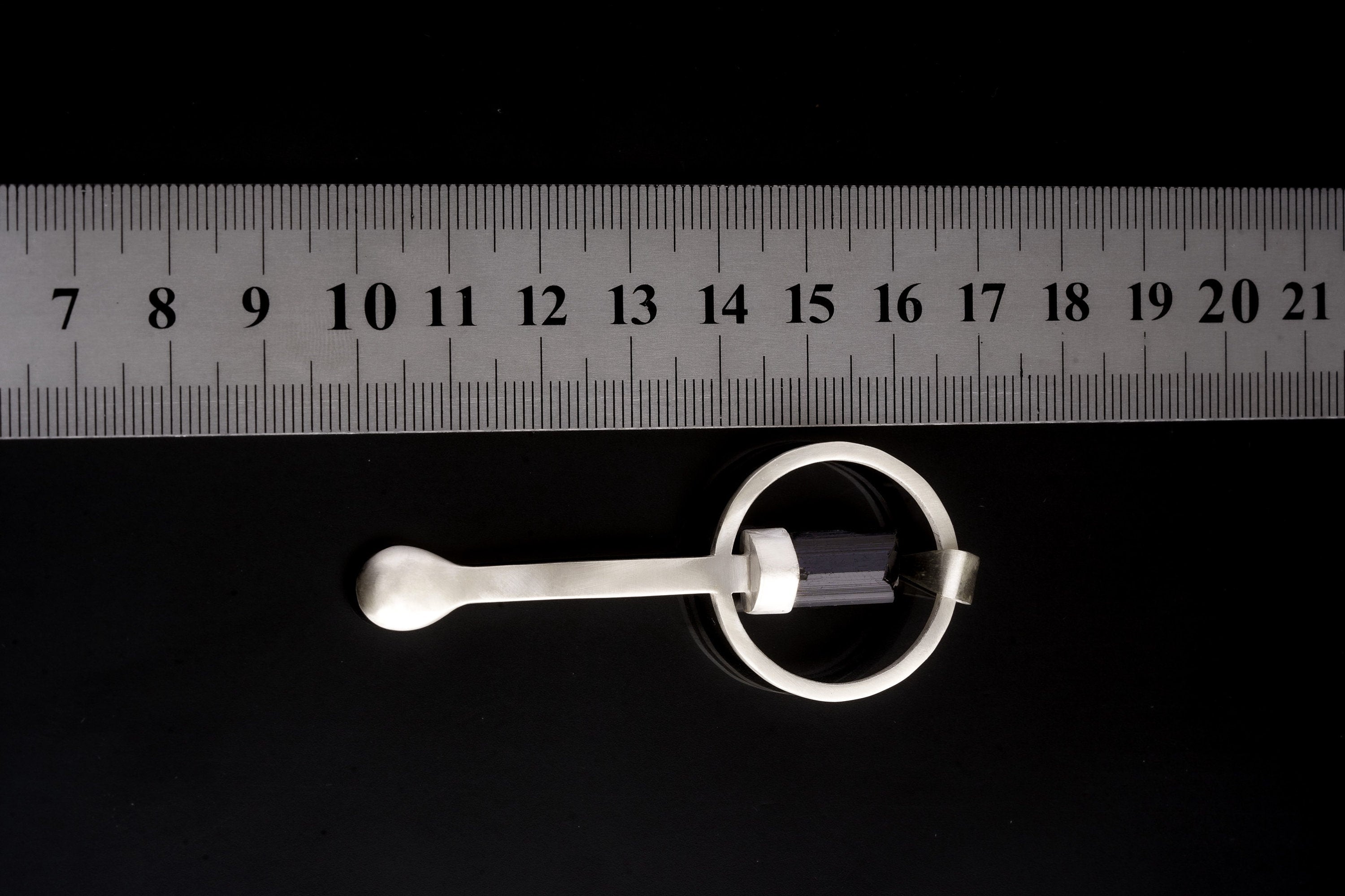 Black Tourmaline sterling silver spoon pendant shown beside a ruler for scale with solid cast silver body.