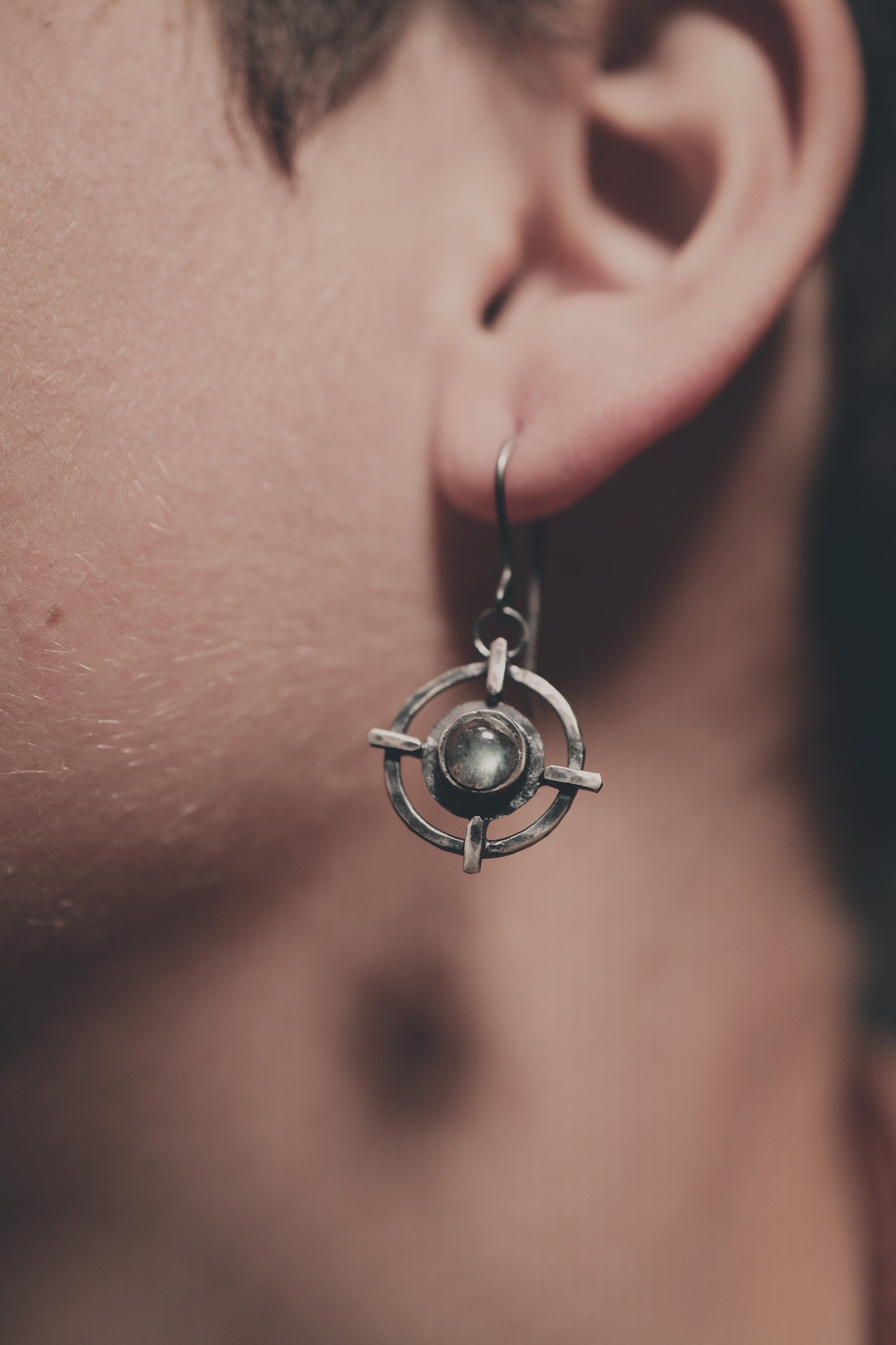 Labradorite Circle Cross earrings shown worn on a model, with sterling silver dangles and symbolic layered design.