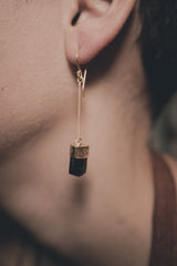 Dravite Tourmaline dangle earrings shown worn on the ear, with warm gold-plated silver and earthy translucent stones.