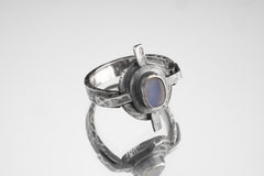 Oxidized Blue Moonstone Compass Ring shown on white background with four directional silver points and hammered texture.