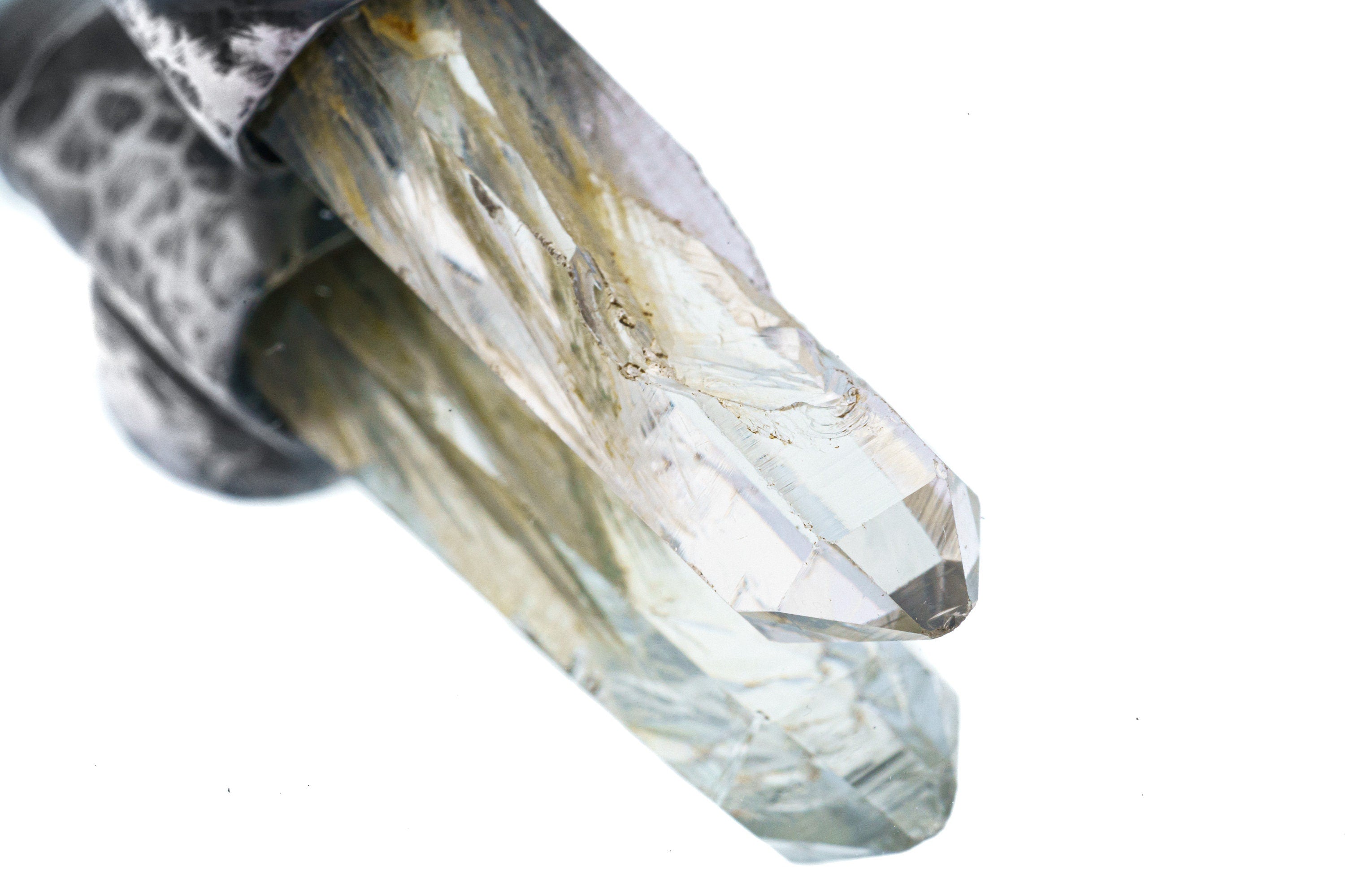 Close-up of Nepal Inclusion Quartz showing green internal mineral character and natural crystal clarity.