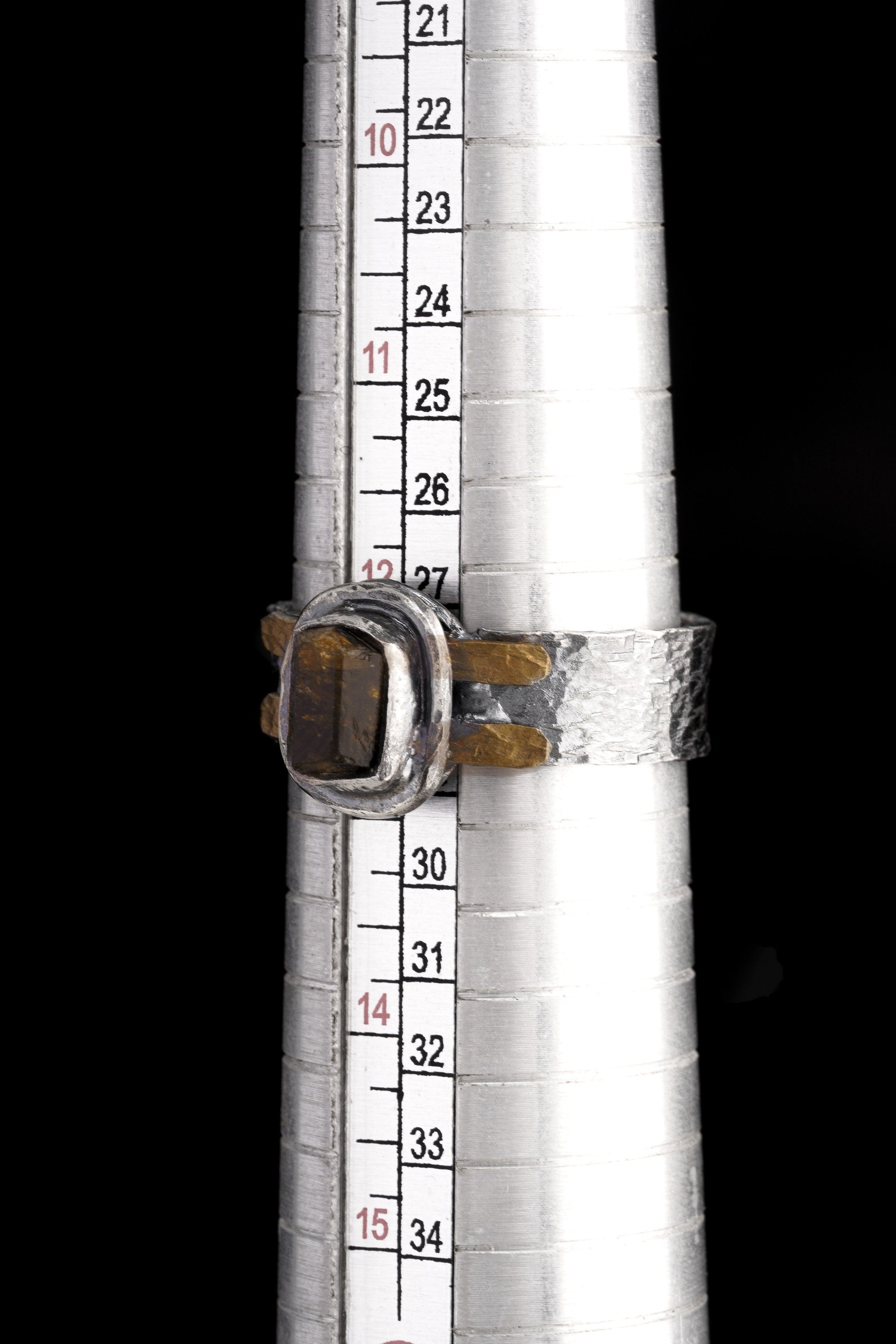 Brown Tourmaline Dravite Silver Ring shown beside a ruler for scale with oxidized silver band and brass accent detail.