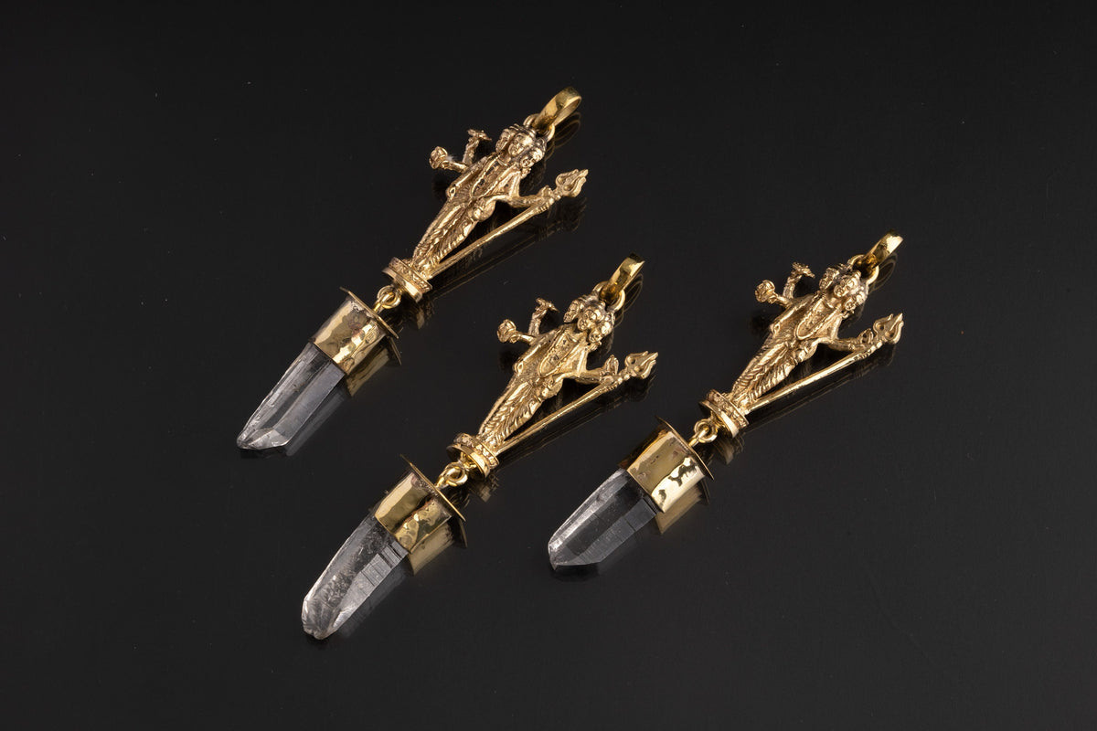 Lord Shiva Clear Quartz talisman pendant shown on a dark background with hammered brass figure and Himalayan Quartz crystal.