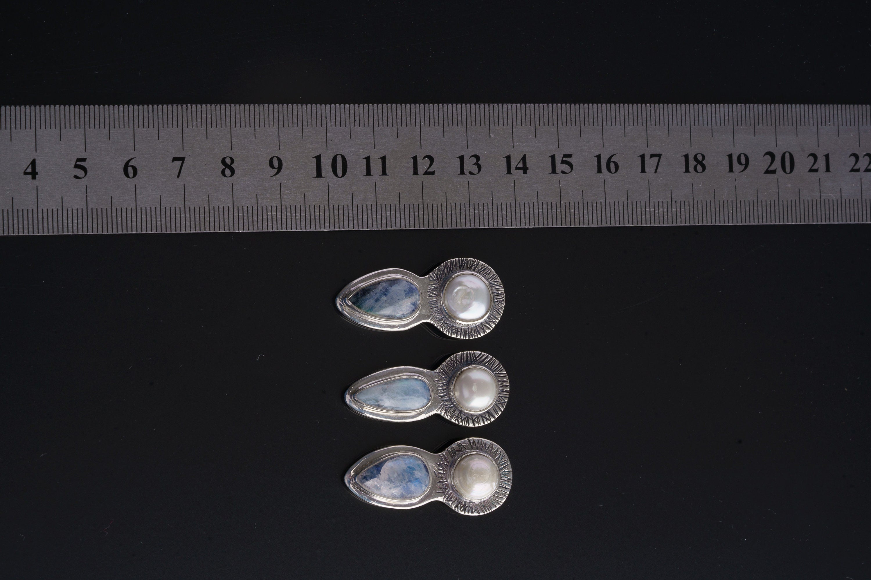 Blue Moonstone Pearl Venus pendant shown beside a ruler for scale with hidden tubular bail.