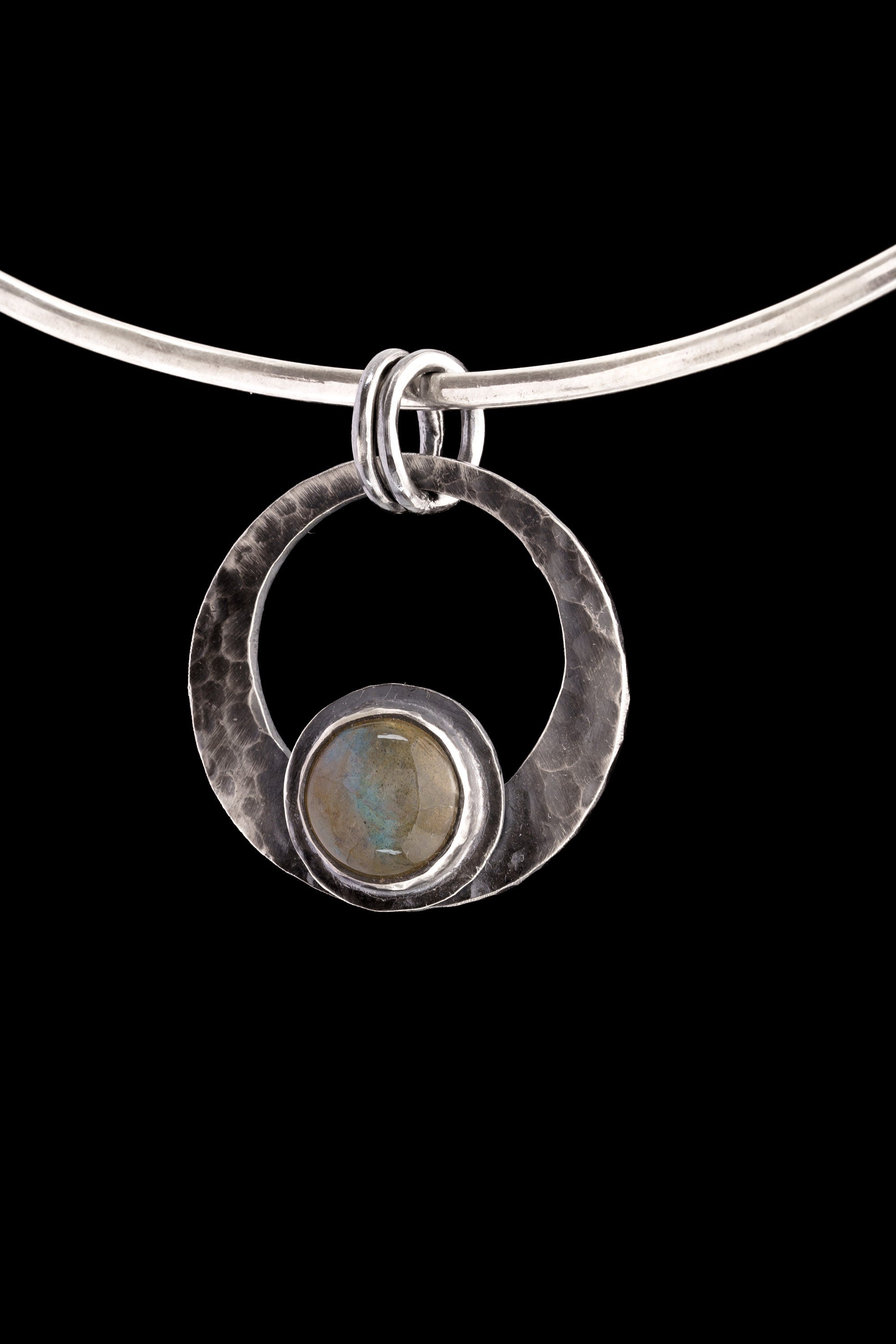 Rainbow Labradorite crescent moon pendant shown on black background with oxidized sterling silver frame and central flash stone.