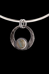 Rainbow Labradorite crescent moon pendant shown on black background with oxidized sterling silver frame and central flash stone.