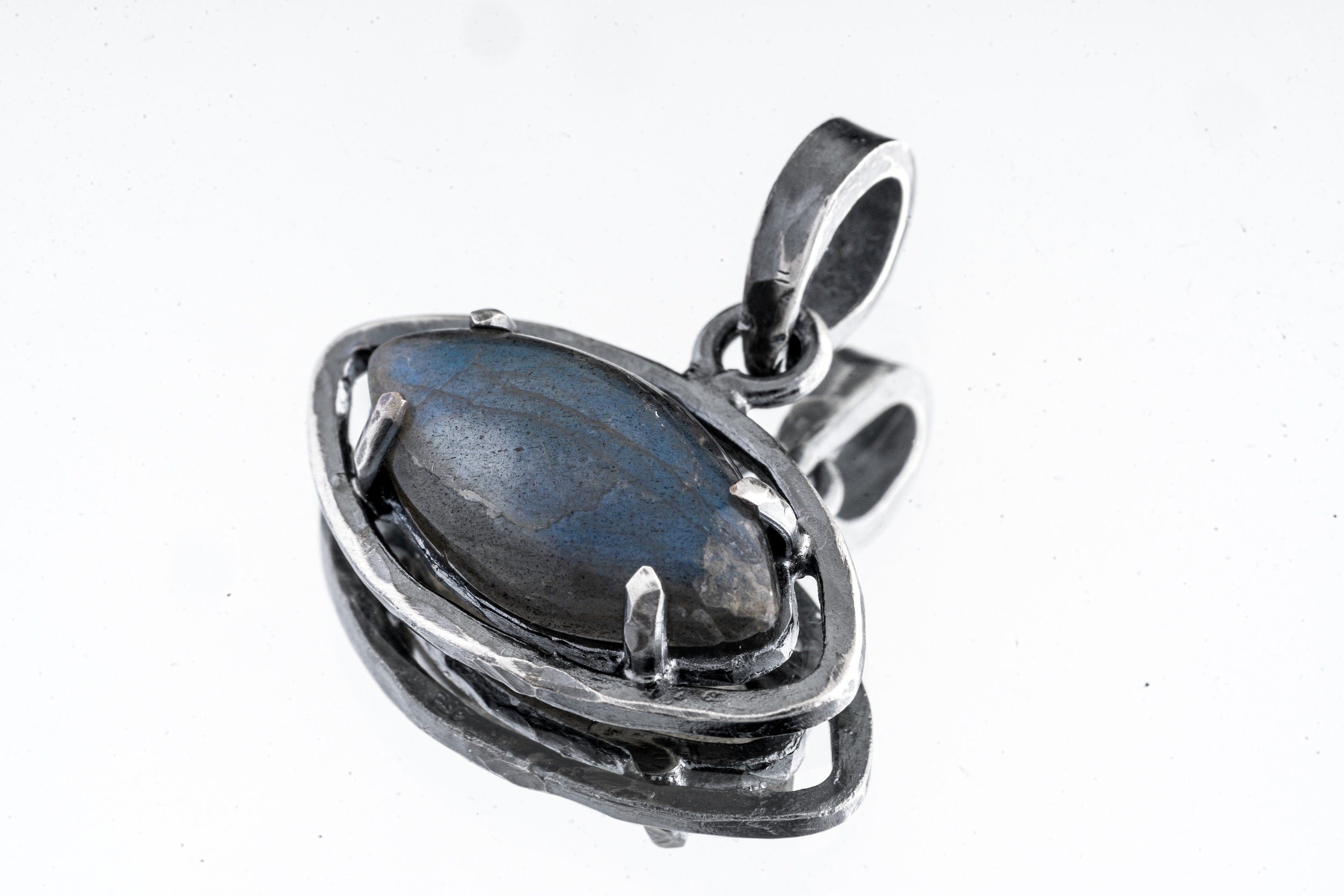 Close-up of an oxidized sterling silver Labradorite claw pendant showing smoky green flash, oval stone shape, and rugged handmade setting.