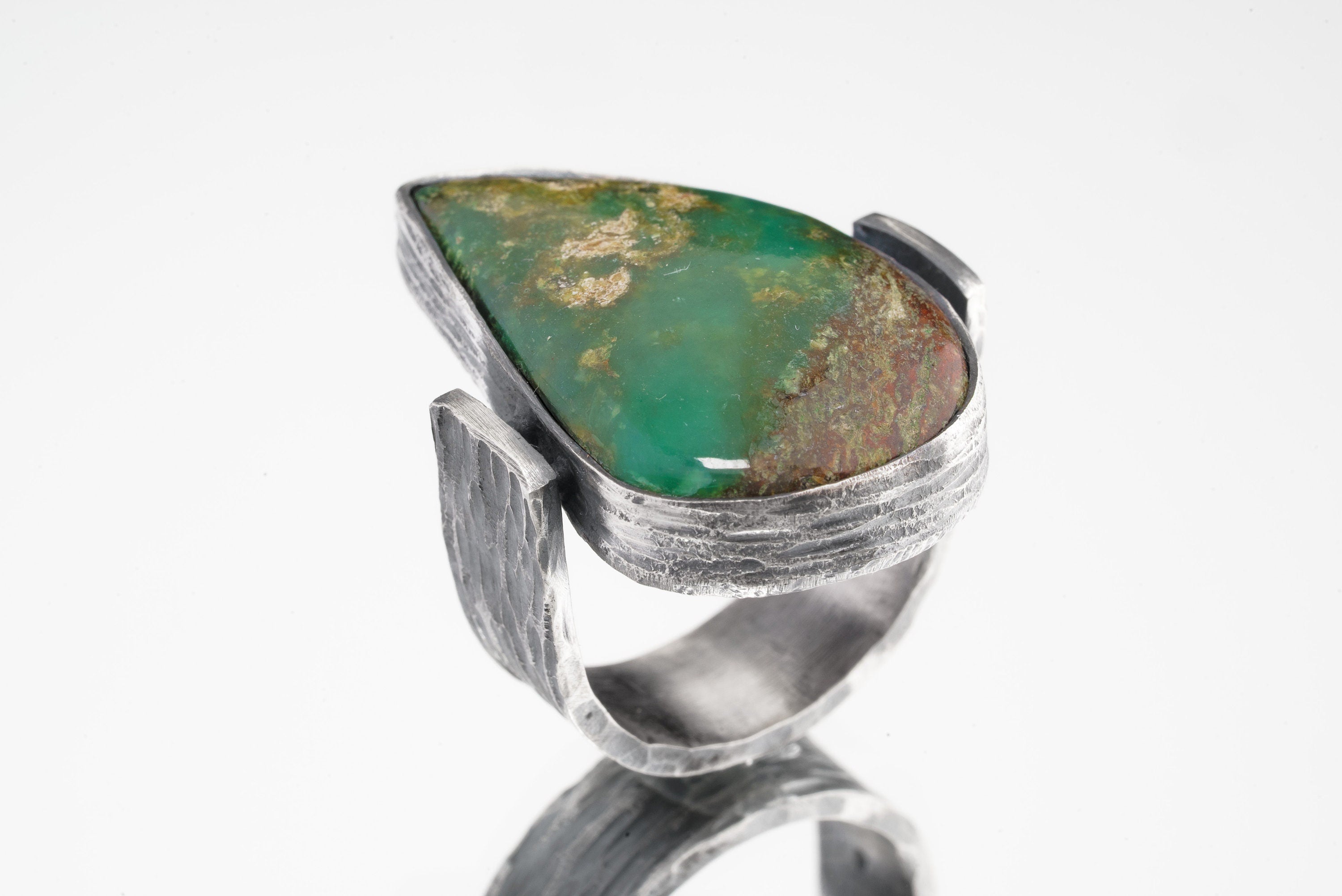 Side view of Chrysoprase Abstract Ring showing oxidized silver texture, raised bezel setting, and solid band construction.
