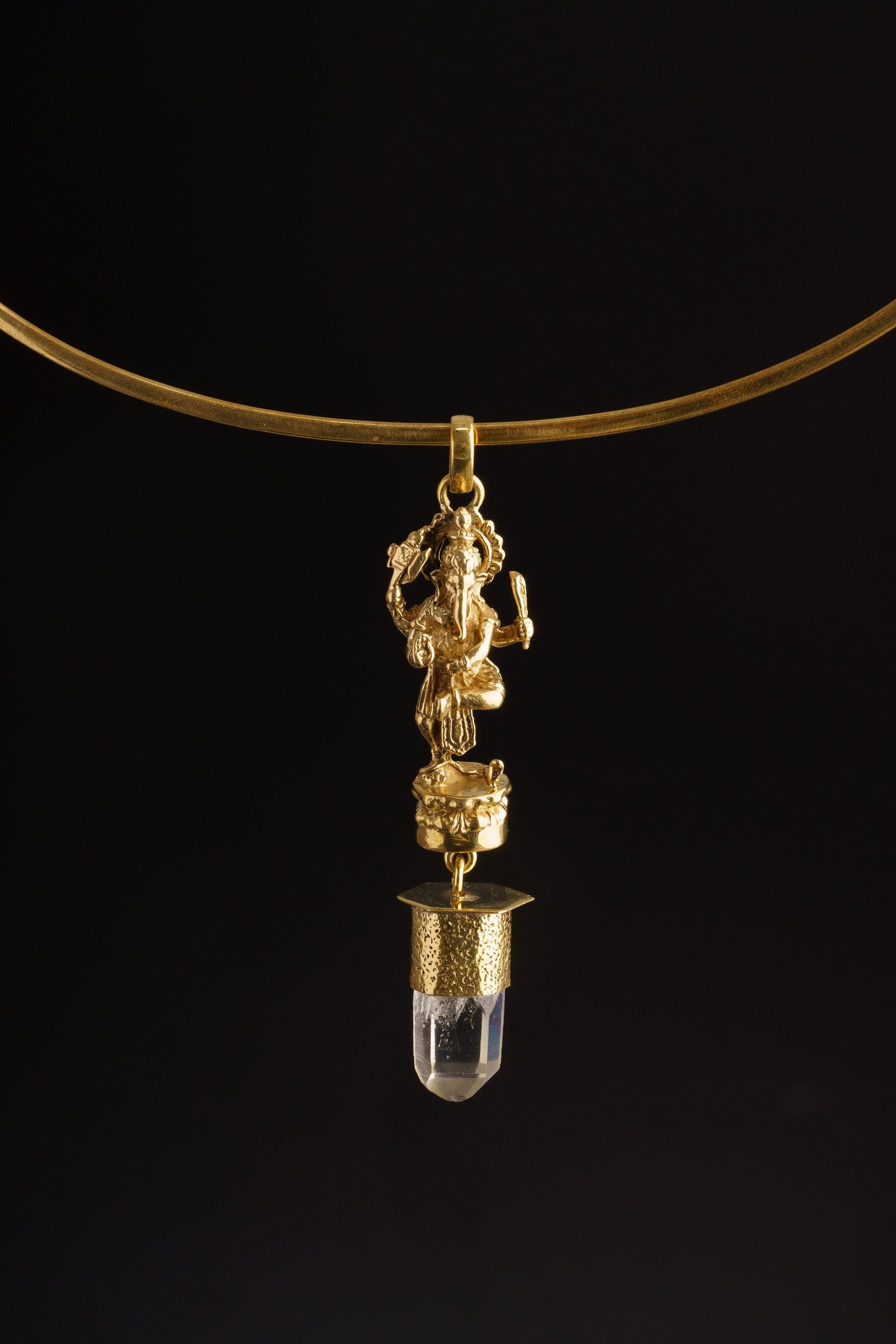 Dancing Ganesha Clear Quartz pendant shown worn on a black background as a lightweight brass spiritual necklace.