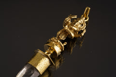 Close-up of brass Dancing Lord Ganesha figure holding a battle axe above Himalayan Clear Quartz.