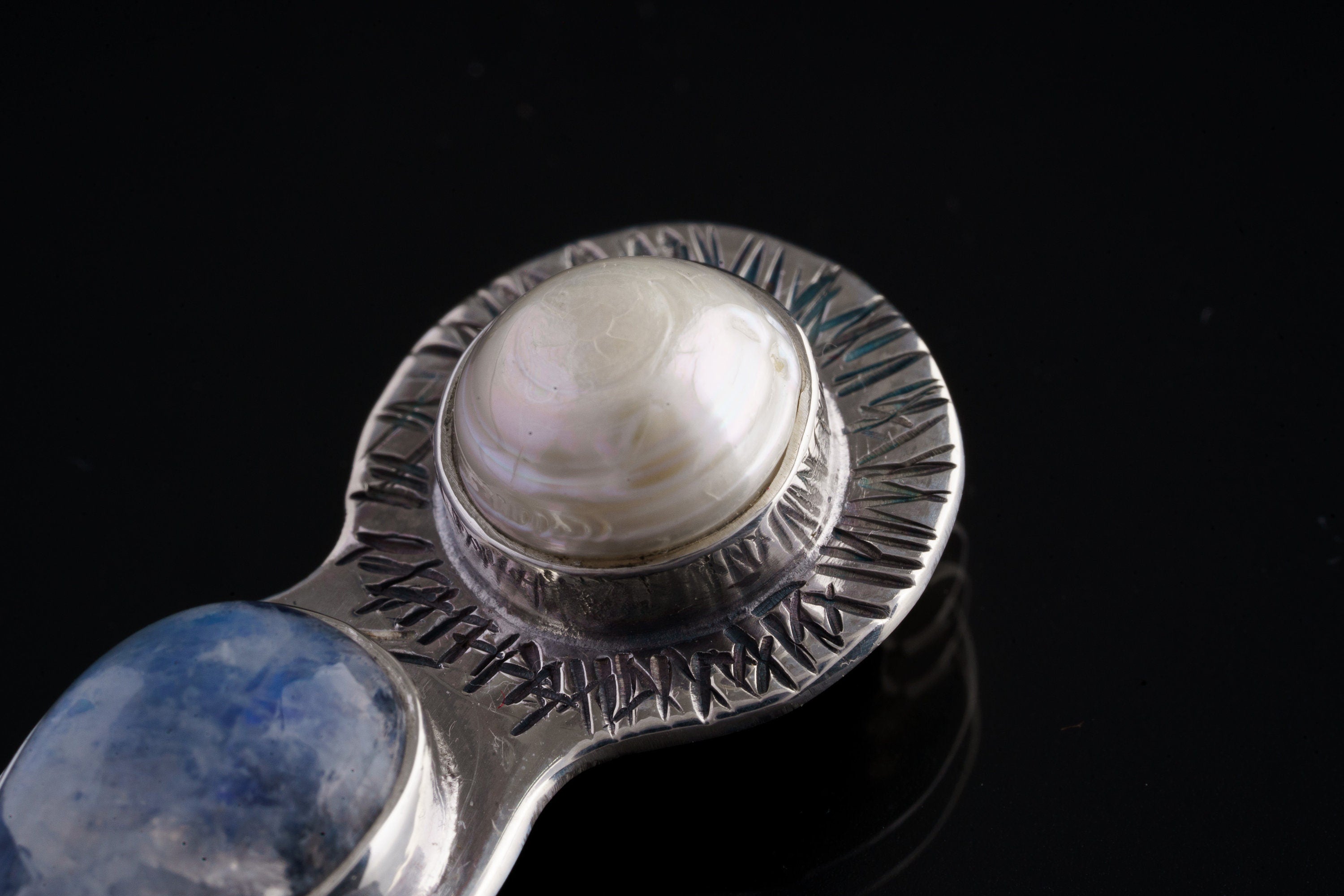 Close-up of South Sea Pearl and Blue Moonstone Venus pendant showing textured sterling silver detail.