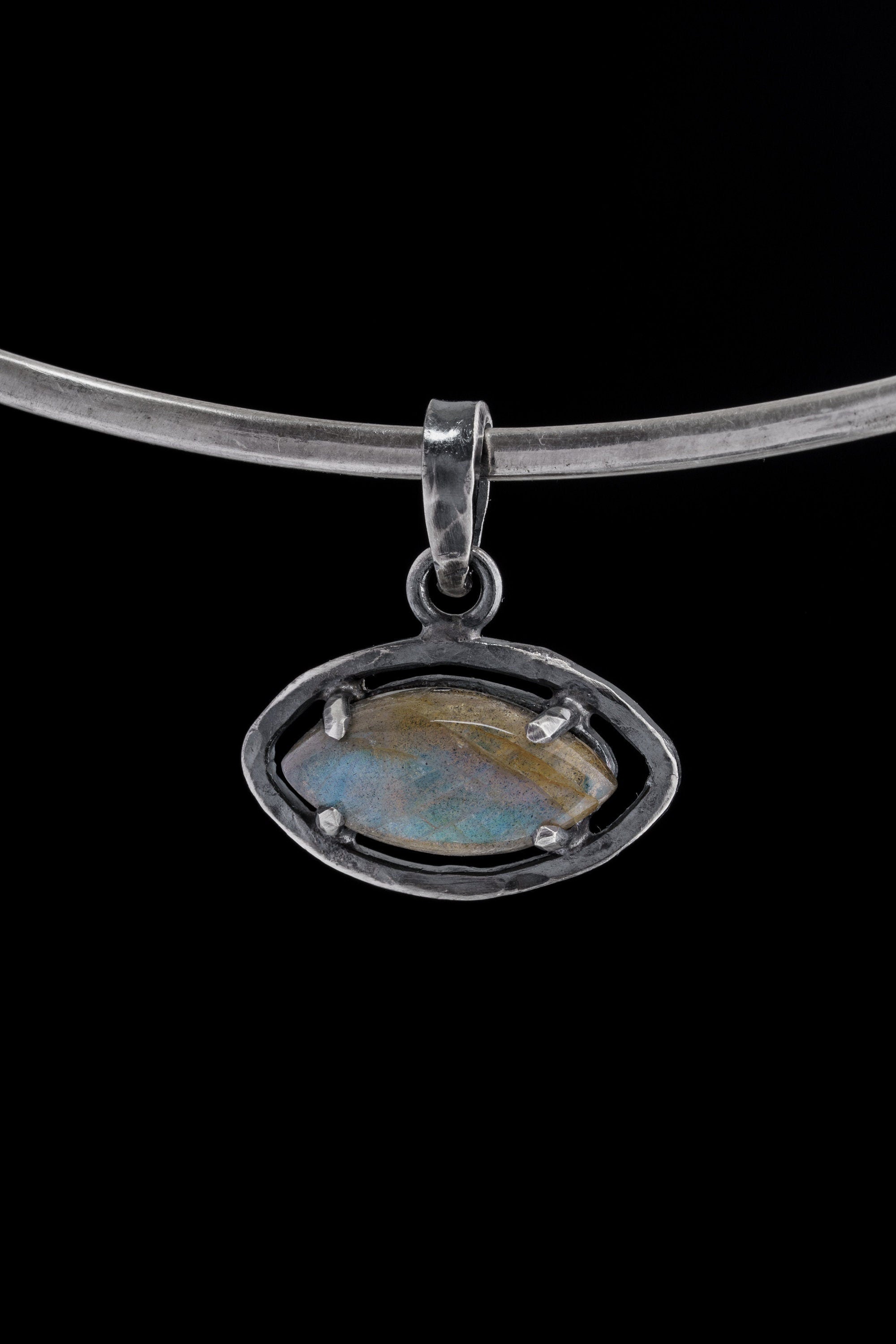 Small oxidized sterling silver Labradorite pendant shown worn on a necklace, with subtle blue-green flash and claw-set detail.