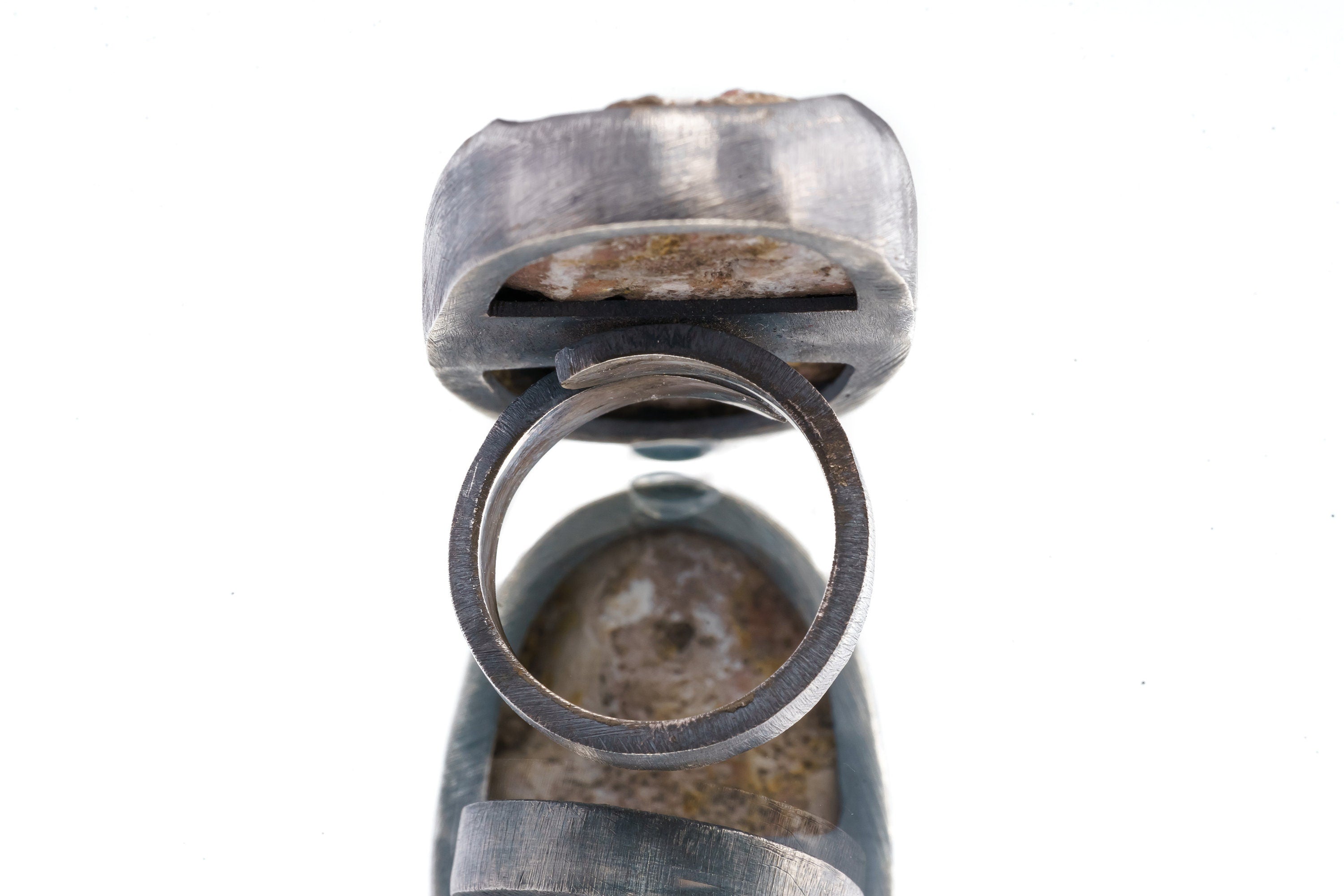 Back view of Garnet and Calcite matrix ring showing the open-back sterling silver construction and adjustable band.