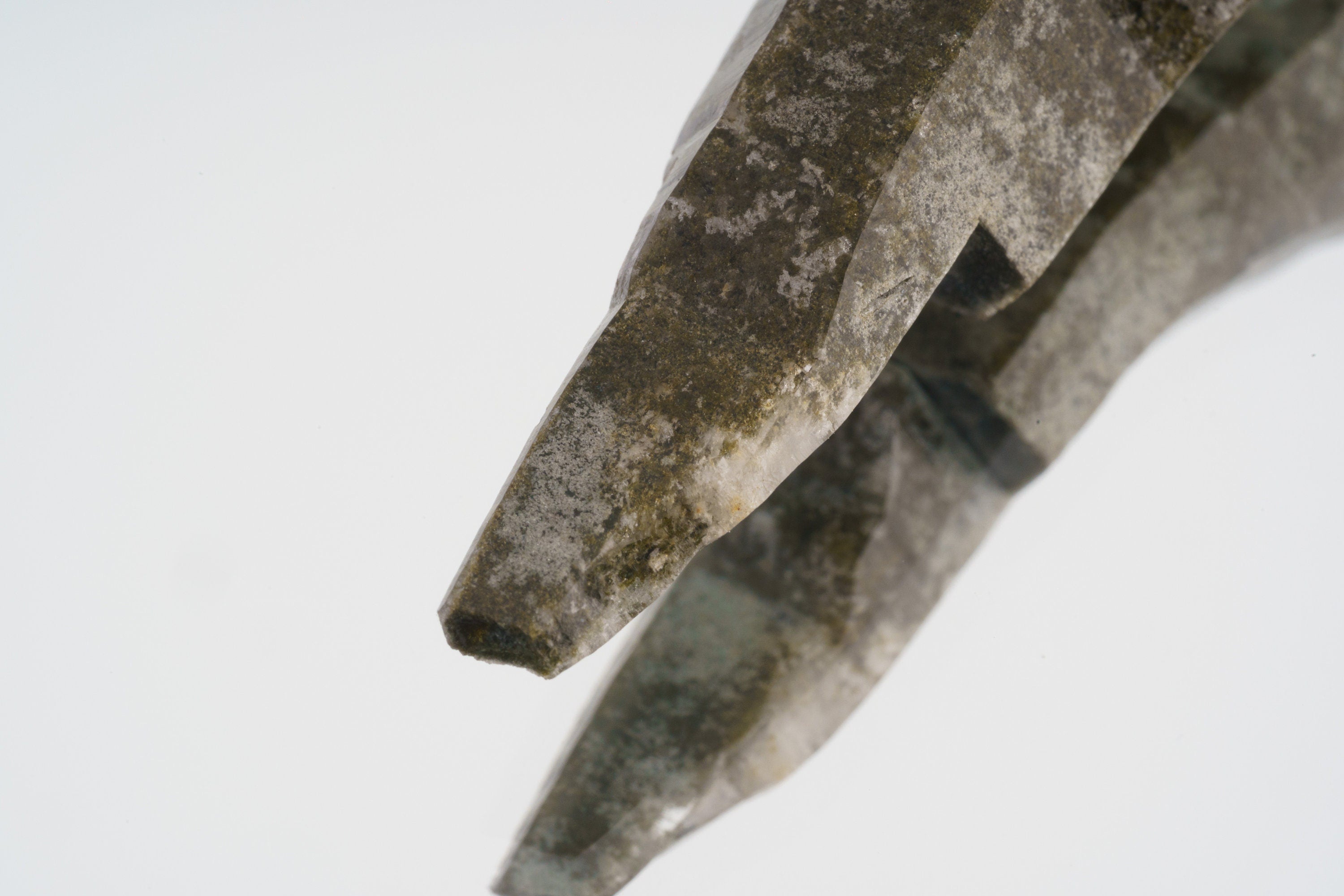 Close-up of double terminated skeletal Himalayan Chlorite Quartz point in a thick oxidized sterling silver wrap setting.