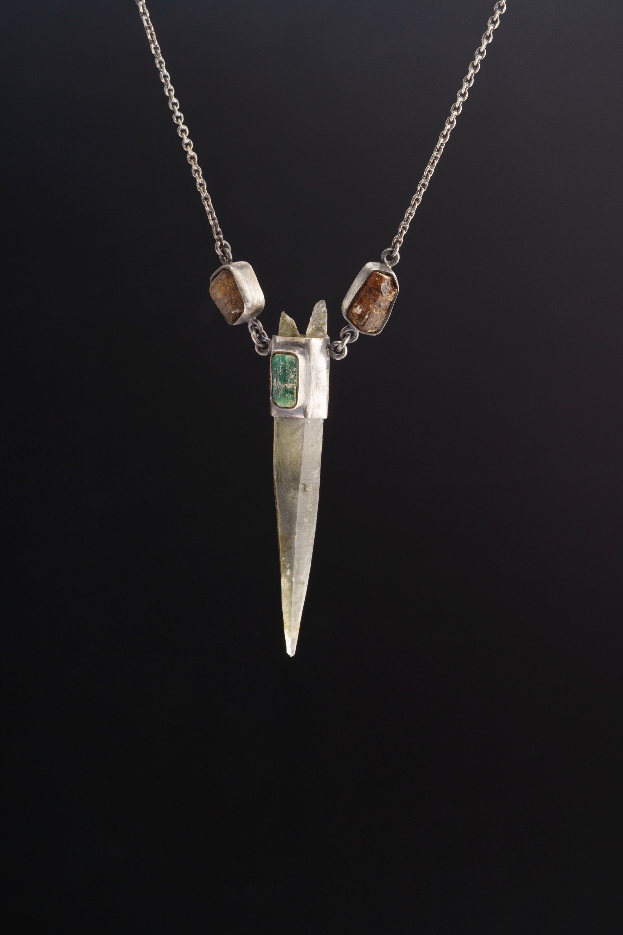 Himalayan Quartz Emerald Dravite Tourmaline pendant shown on black background with long clear Quartz point and oxidized silver chain.
