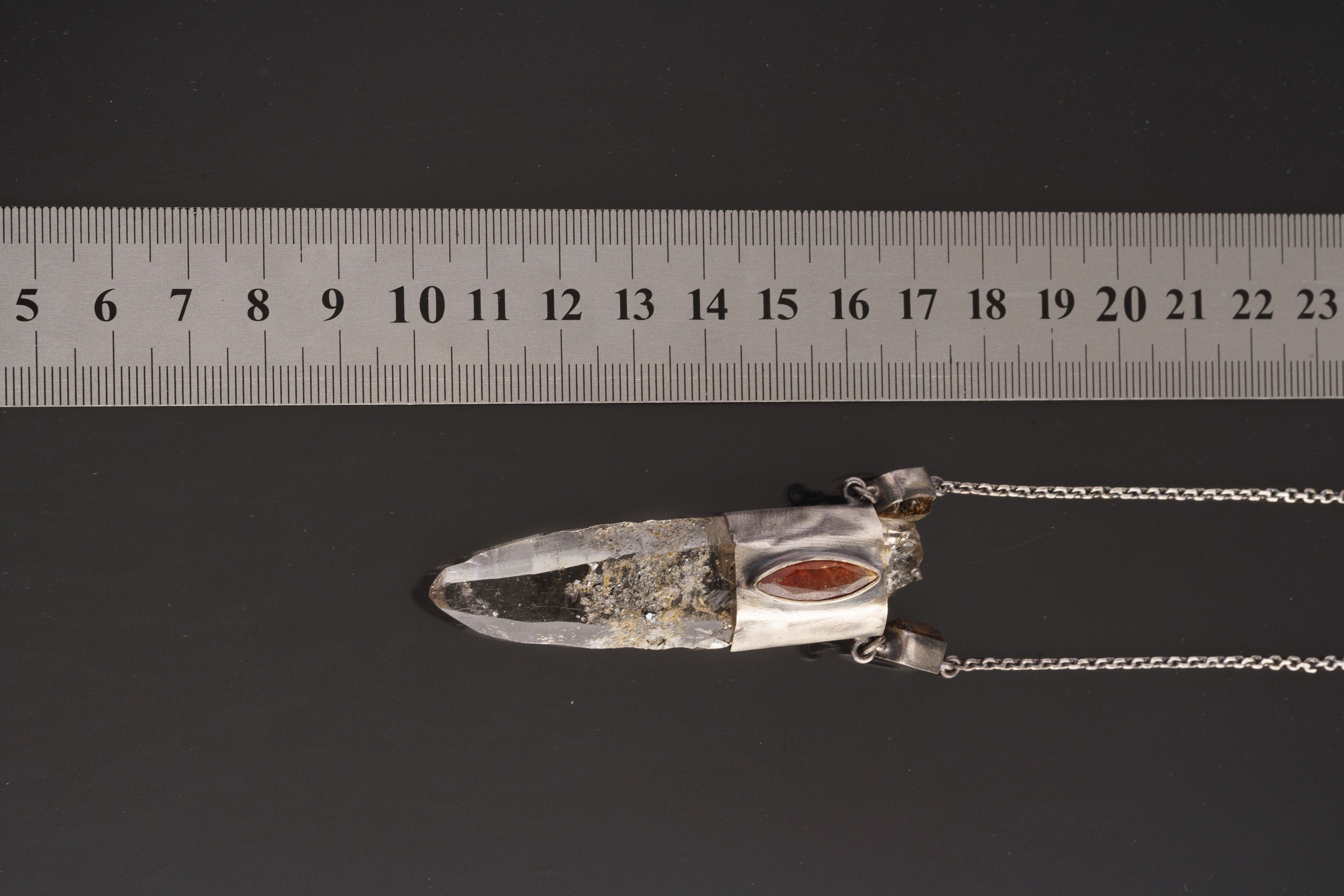 Himalayan Vision Pendant shown beside a ruler for scale with oxidized silver wrap setting and long Quartz point.