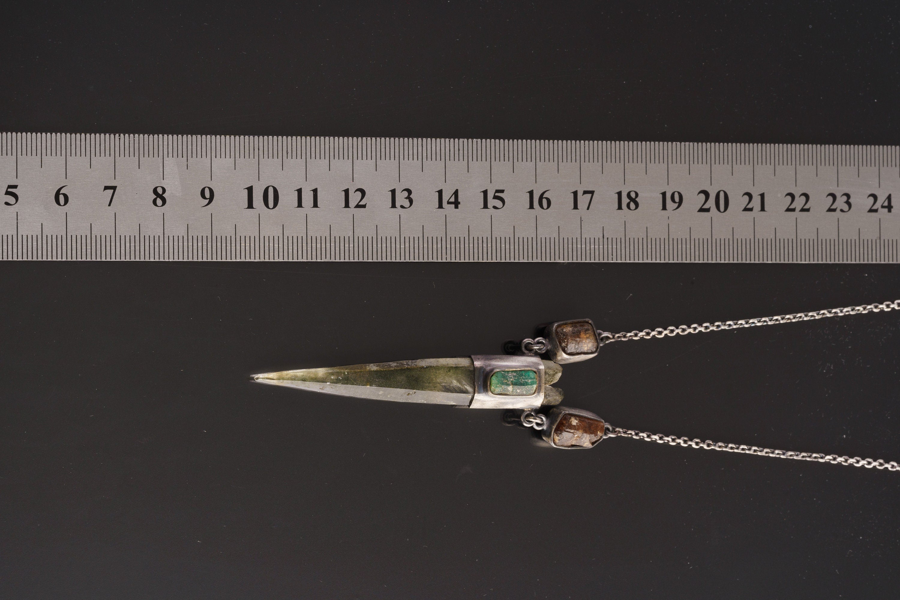 Himalayan Quartz Emerald Dravite Tourmaline pendant shown beside a ruler for scale with oxidized silver wrap setting.