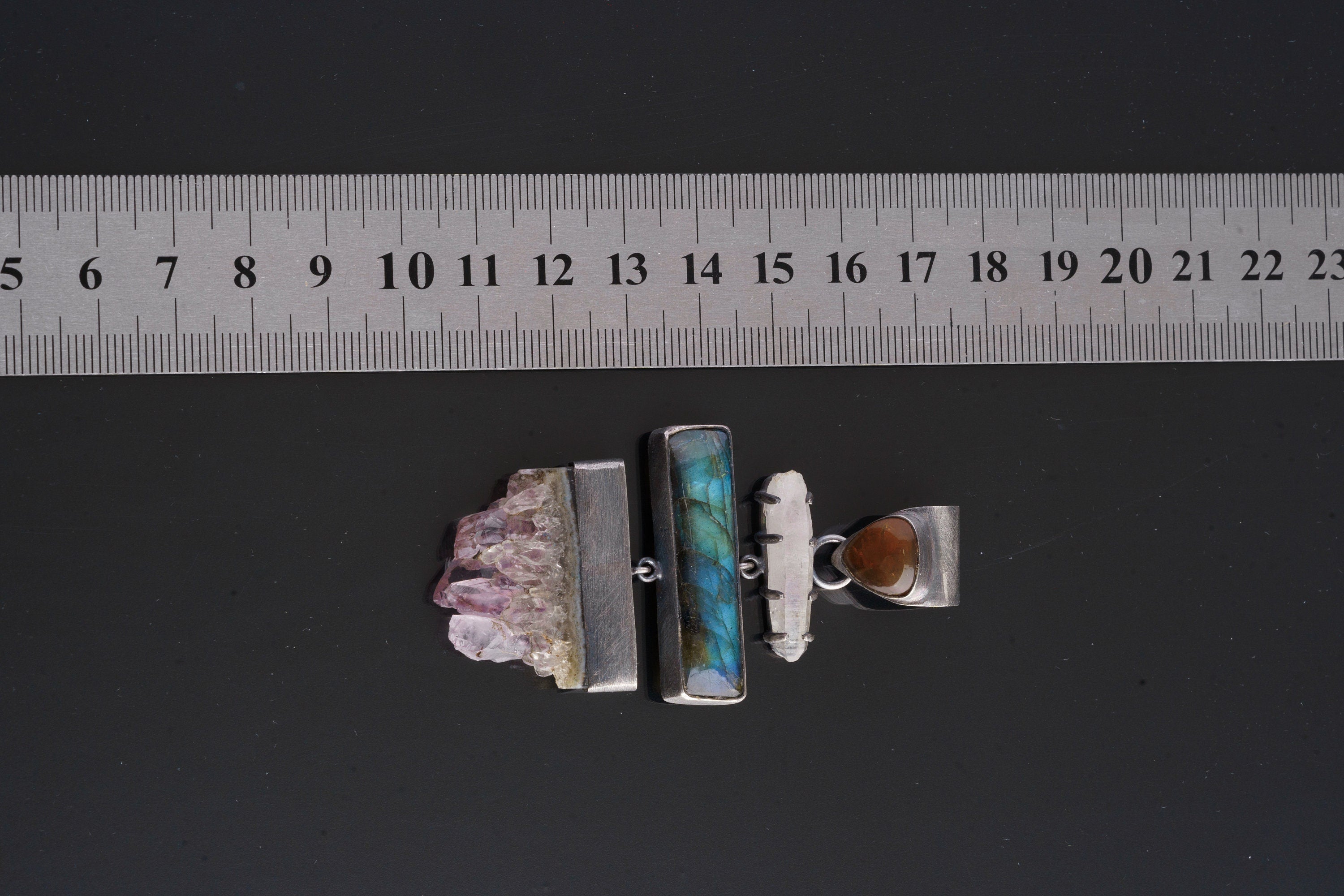 Amethyst Labradorite Opal Lemurian Quartz pendant shown beside a ruler for scale with oxidized silver setting.