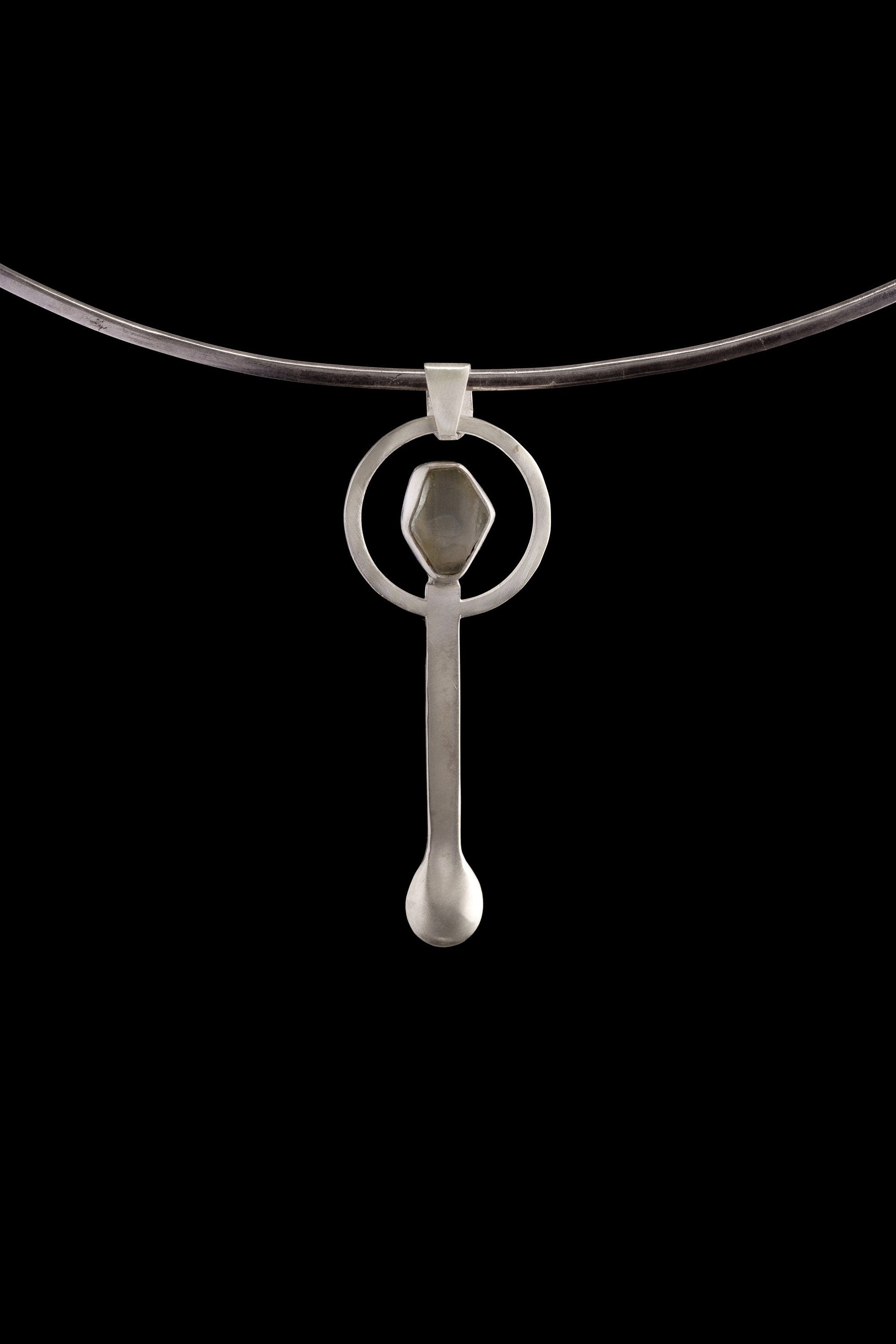 Aquamarine sterling silver spoon pendant displayed on a choker, showing wearable talisman styling.