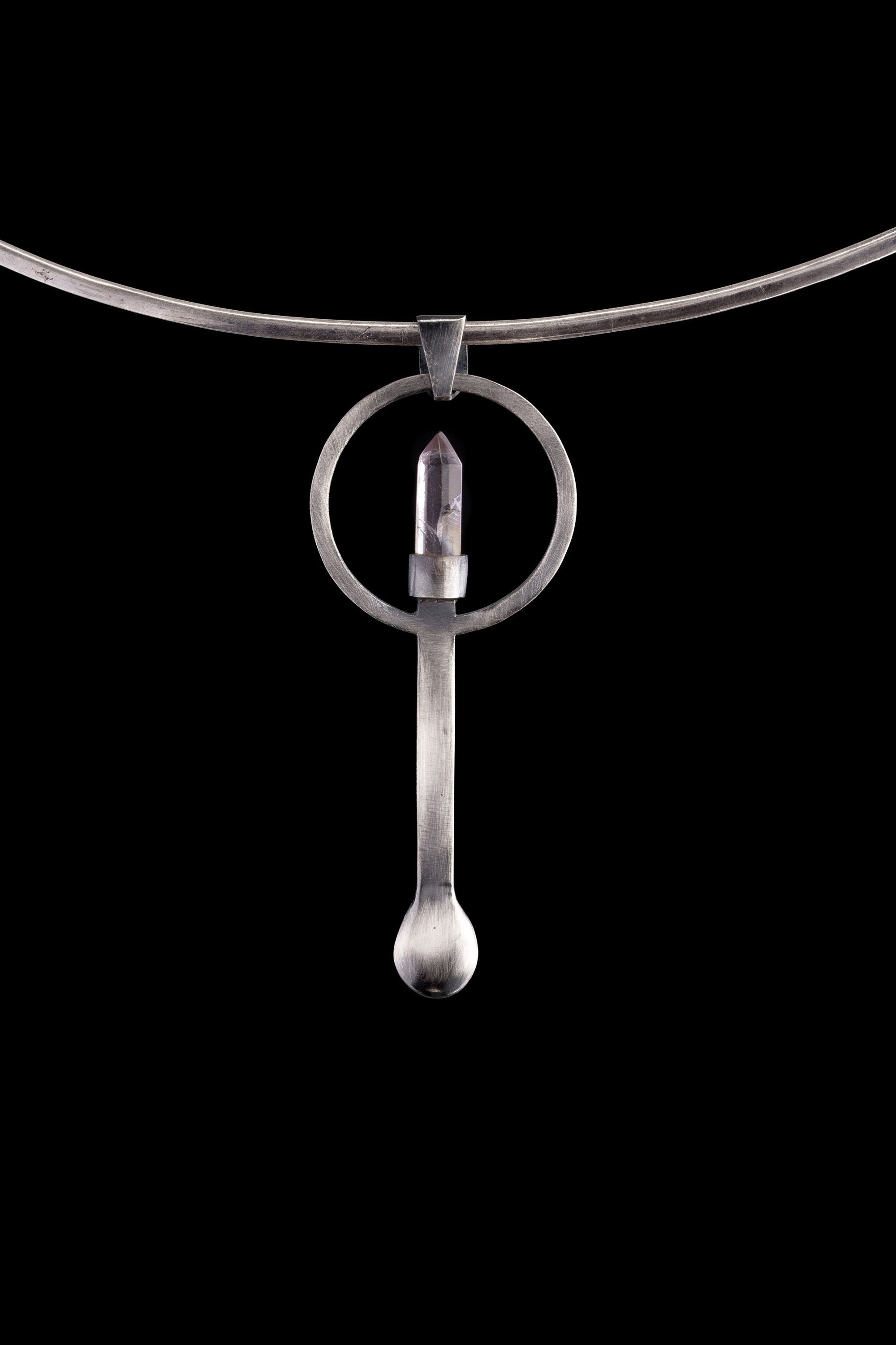 Clear Quartz Generator silver spoon pendant displayed on a choker, showing wearable talisman styling and spoon form.