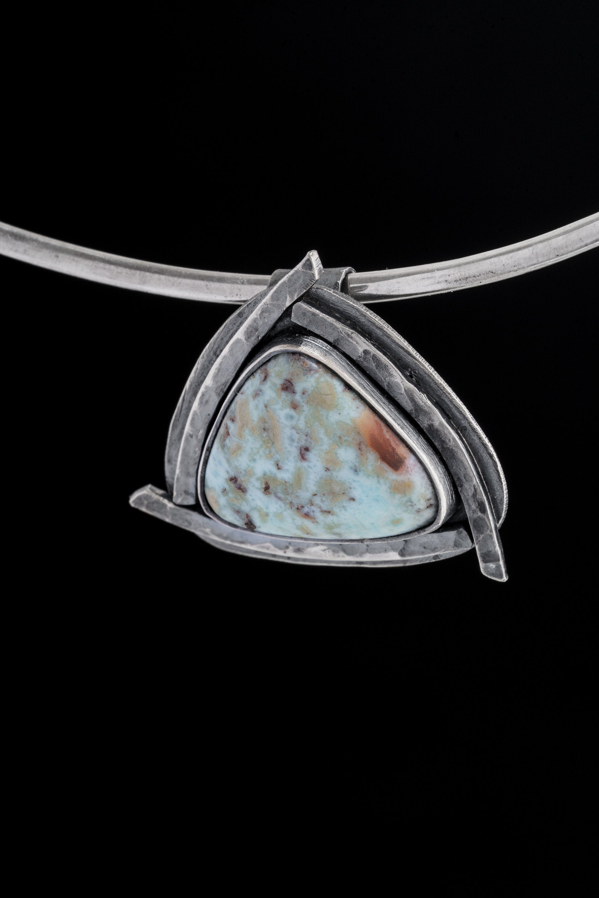 Larimar triangle pendant displayed on a choker against black background with concealed tubular bail.