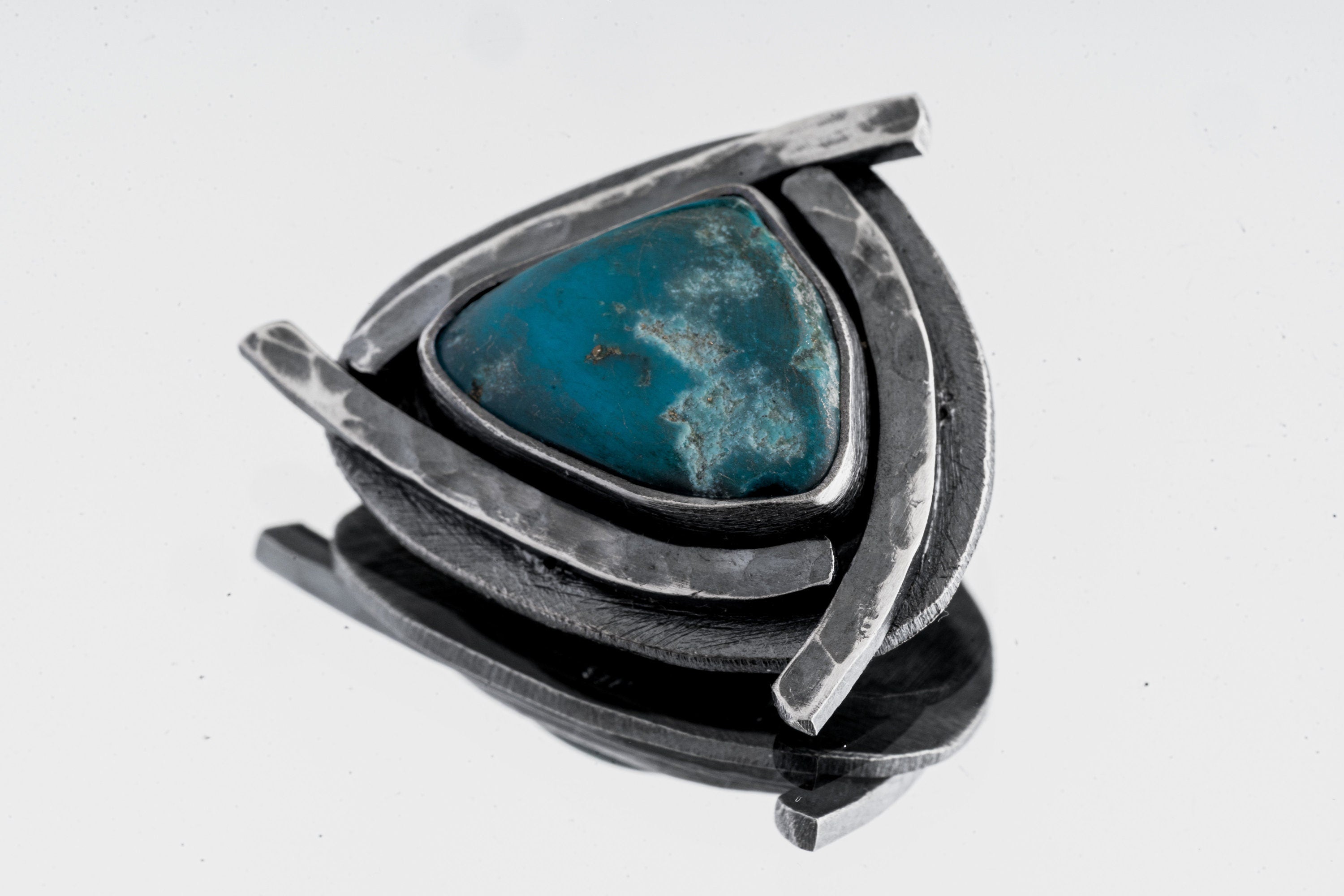 Sleeping Beauty Turquoise pendant shown on white background with sky-blue stone and oxidized silver triangle frame.