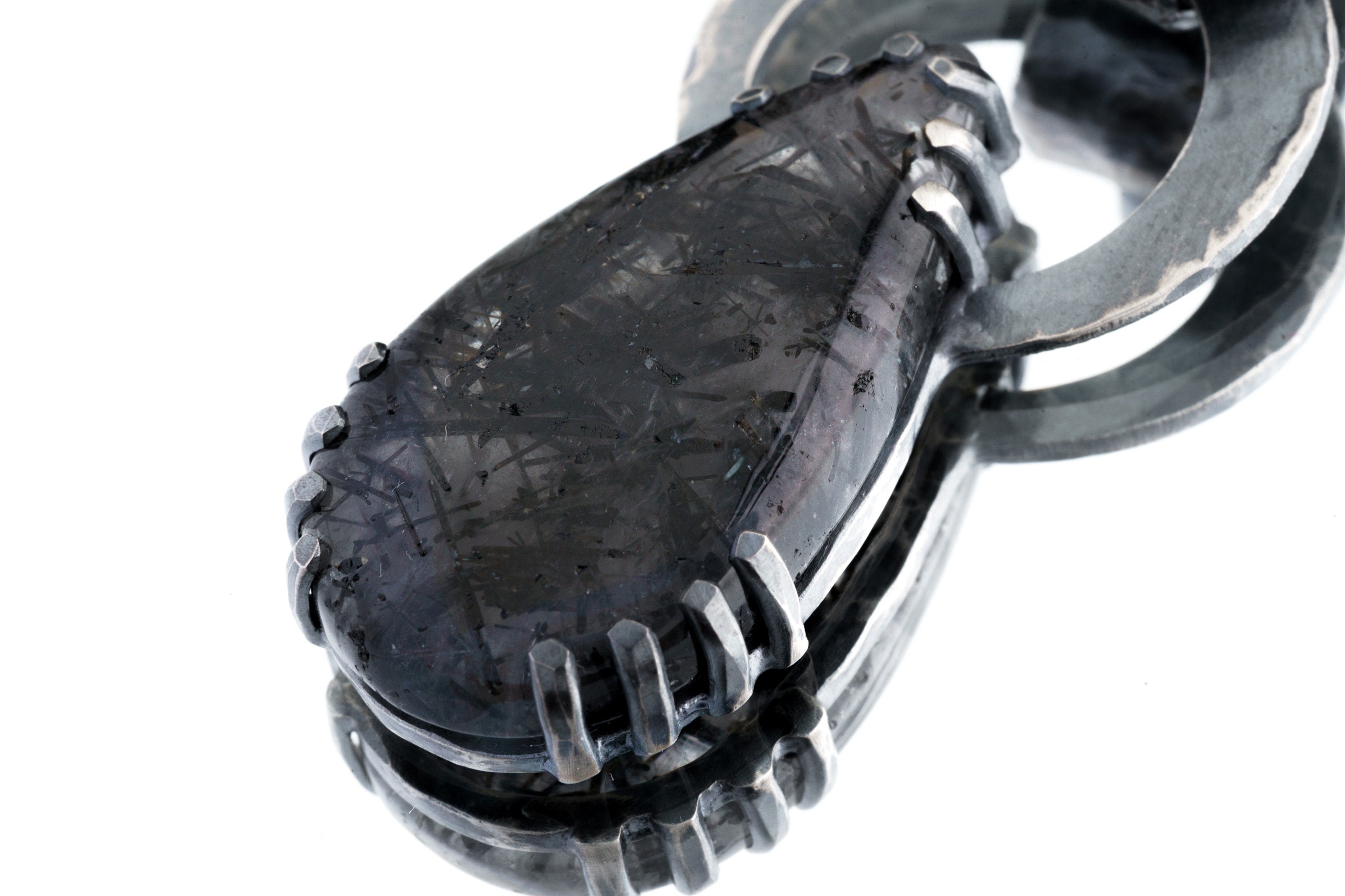 Raw teardrop Moonstone held in brutalist oxidized sterling silver claw setting.