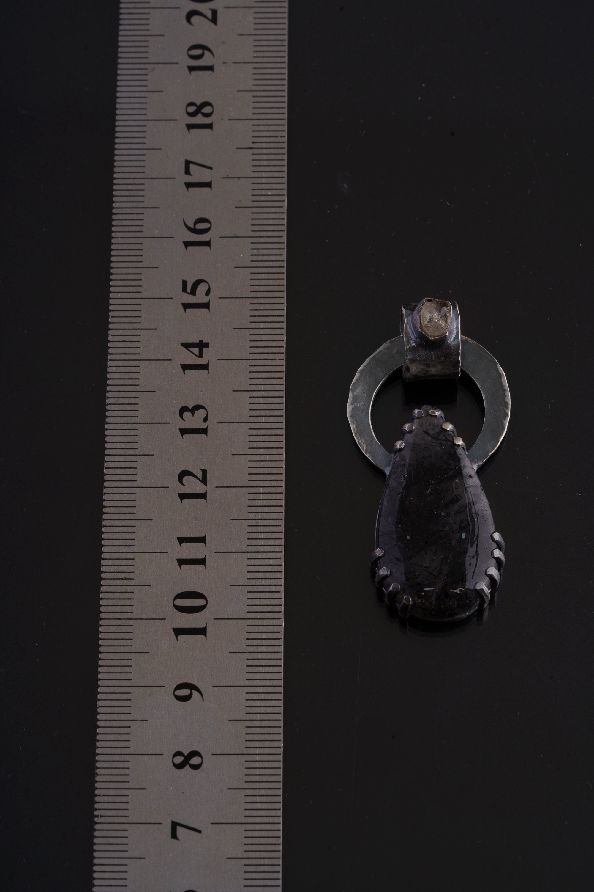 Raw Moonstone Black Rutile Quartz pendant shown beside ruler for approximate size reference.