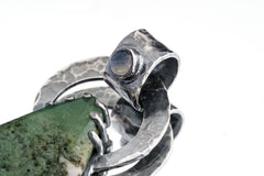 Cat Eye Moonstone Moss Agate pendant shown close-up with teardrop stone and heavy silver backing.