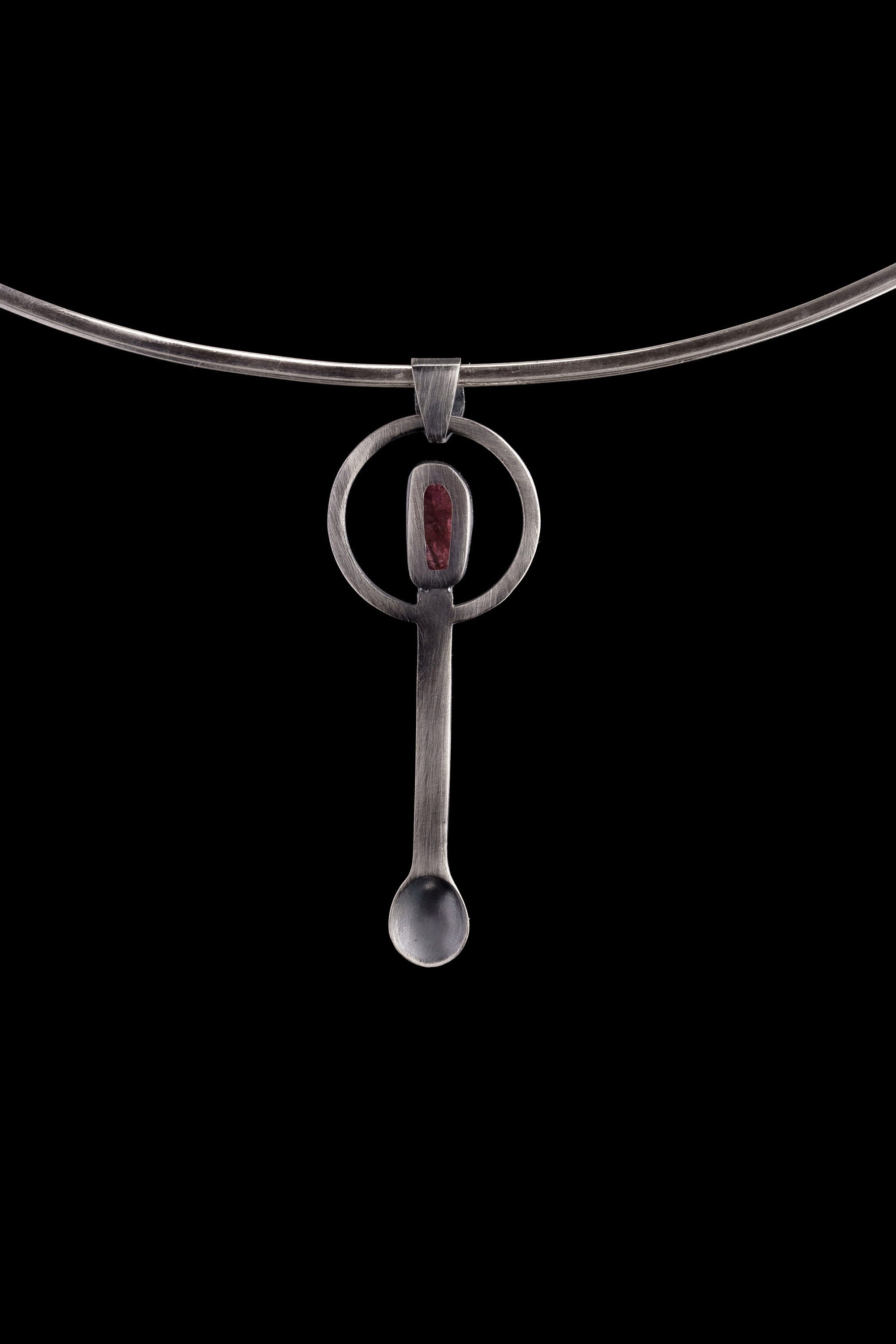Rubellite Tourmaline spoon pendant shown on a silver choker with brushed sterling silver and heart-centred crystal detail.