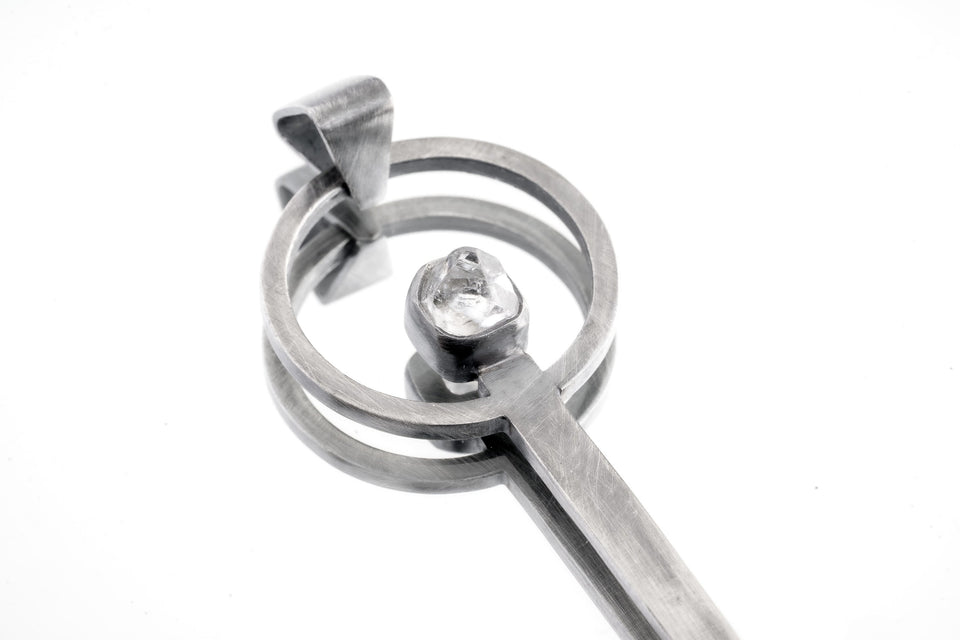 Himalayan Laser Quartz spoon pendant shown close-up with solid 925 sterling silver and clear pointed crystal.