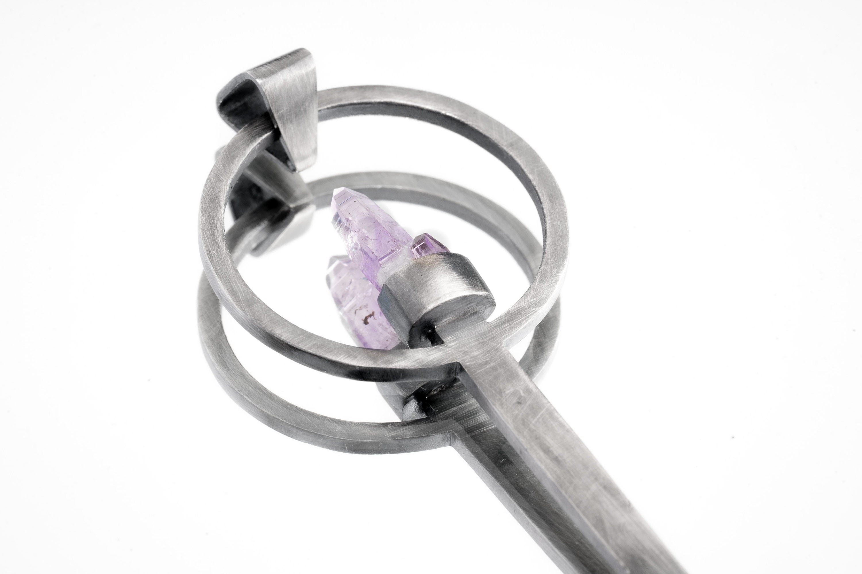 Close-up of Twin Vera Cruz Amethyst spoon pendant showing brush-textured silver and delicate twin crystal setting.