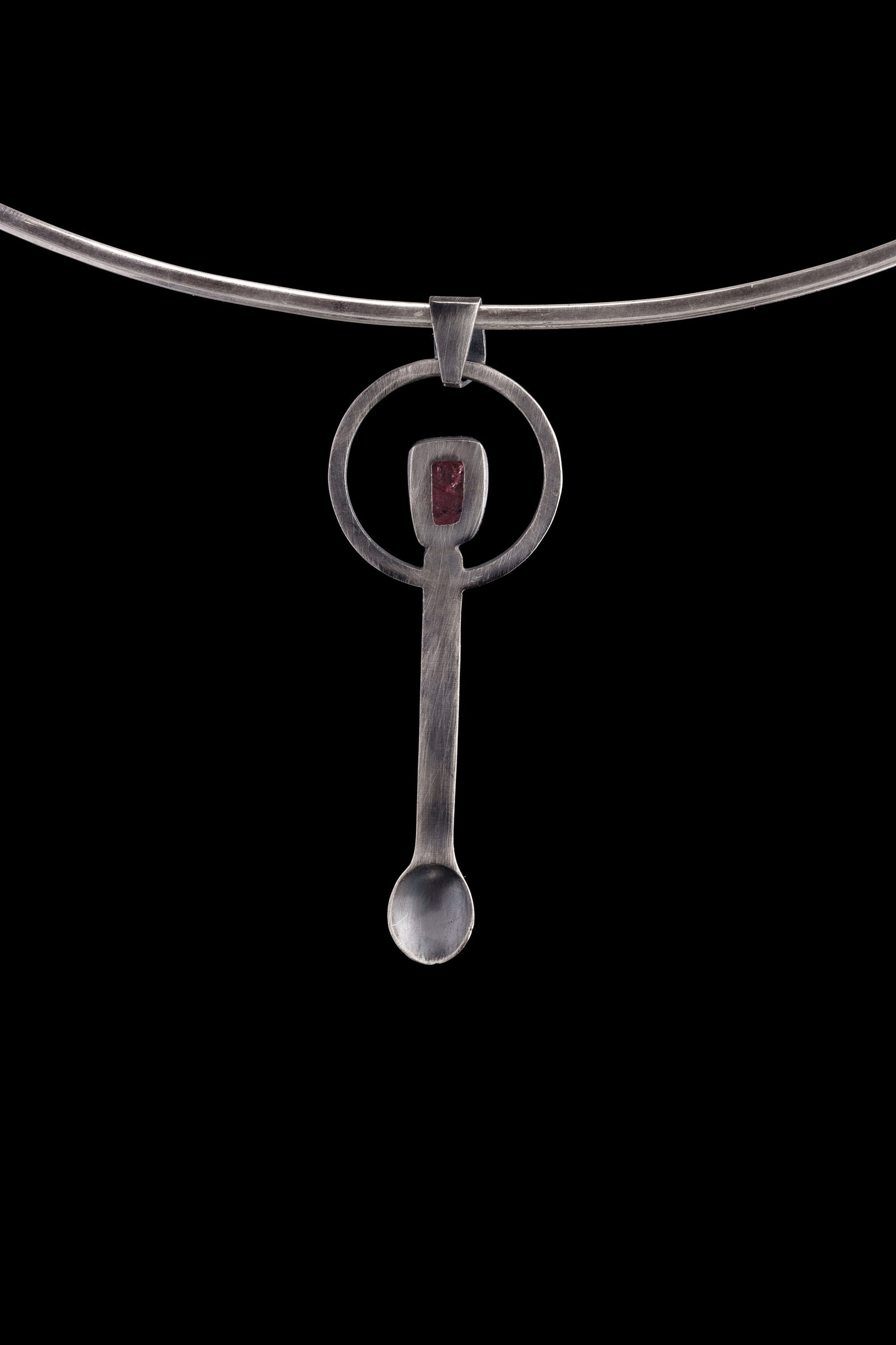 Pink Tourmaline spoon pendant shown on a silver choker with brushed sterling silver and heart-centred crystal detail.