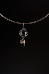 Brown Tourmaline and Ethiopian Opal sphere pendant shown on a black cord, with open oxidized silver wire sphere design.