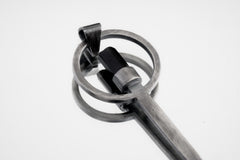 Close-up of Black Tourmaline spoon pendant showing hammer-textured sterling silver and protective dark stone.