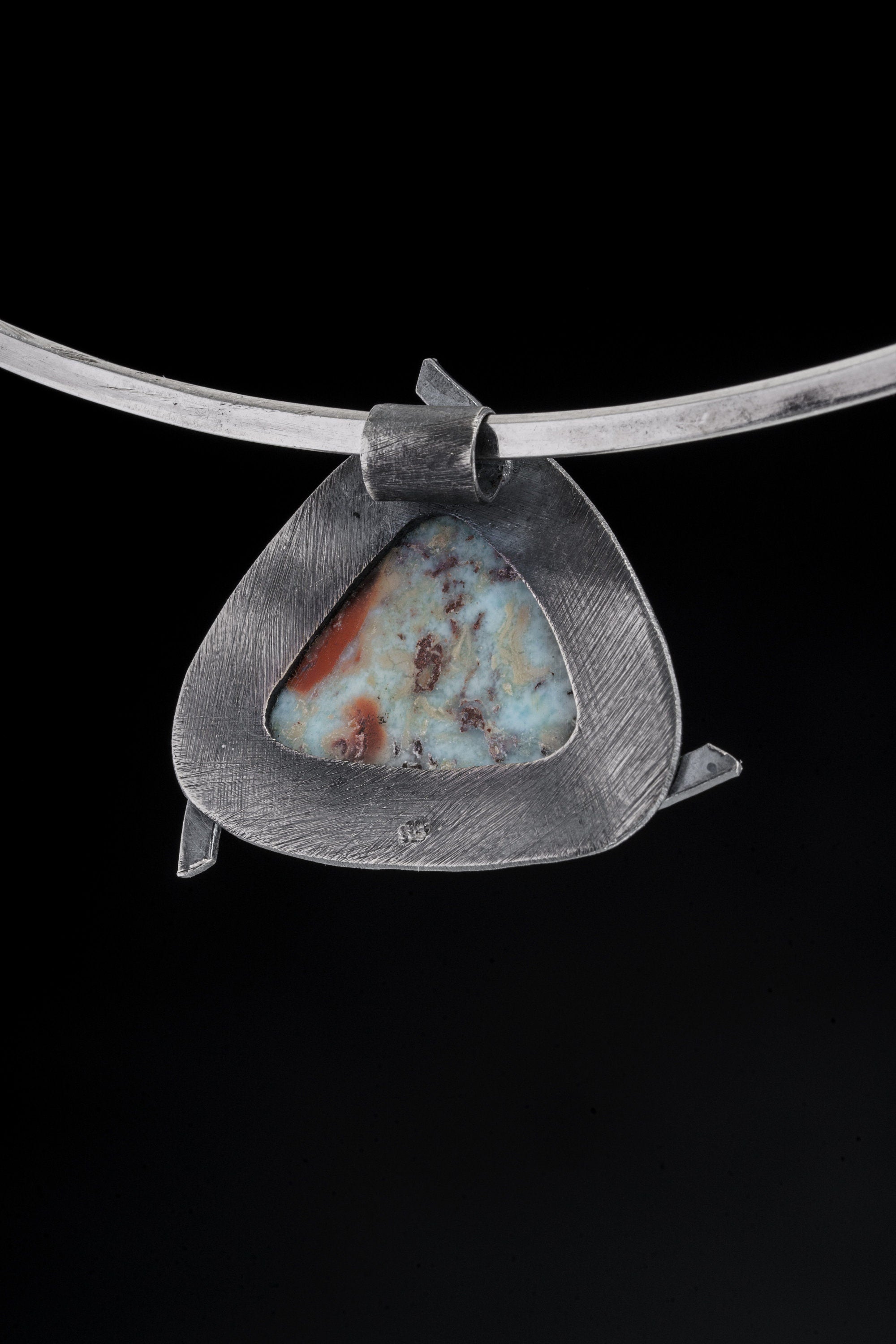 Larimar pendant shown from the back with open-back sterling silver triangle construction.
