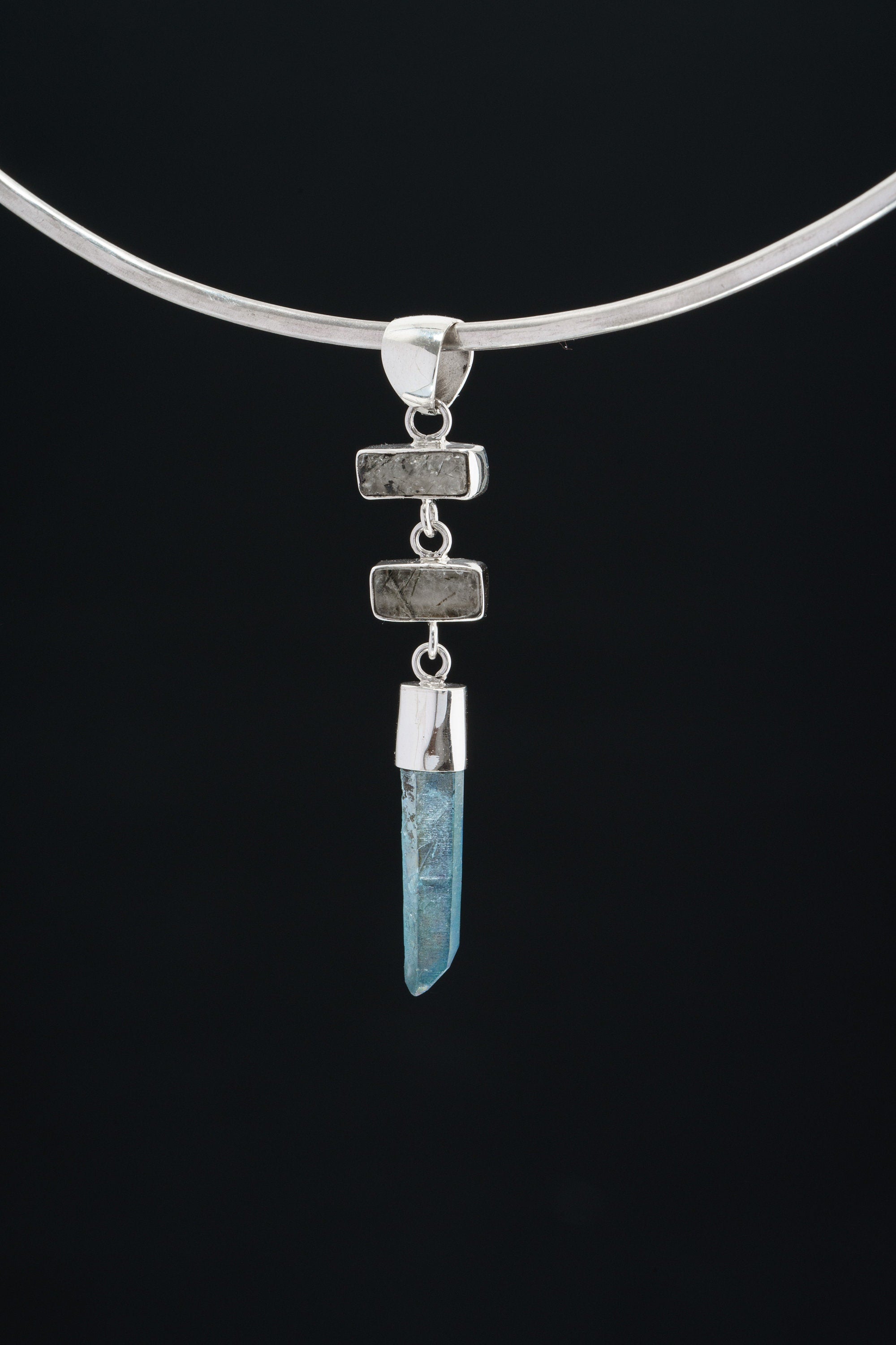 Black Rutile Quartz and Lemurian Aqua Aura pendant displayed on dark background with high-shine sterling silver.