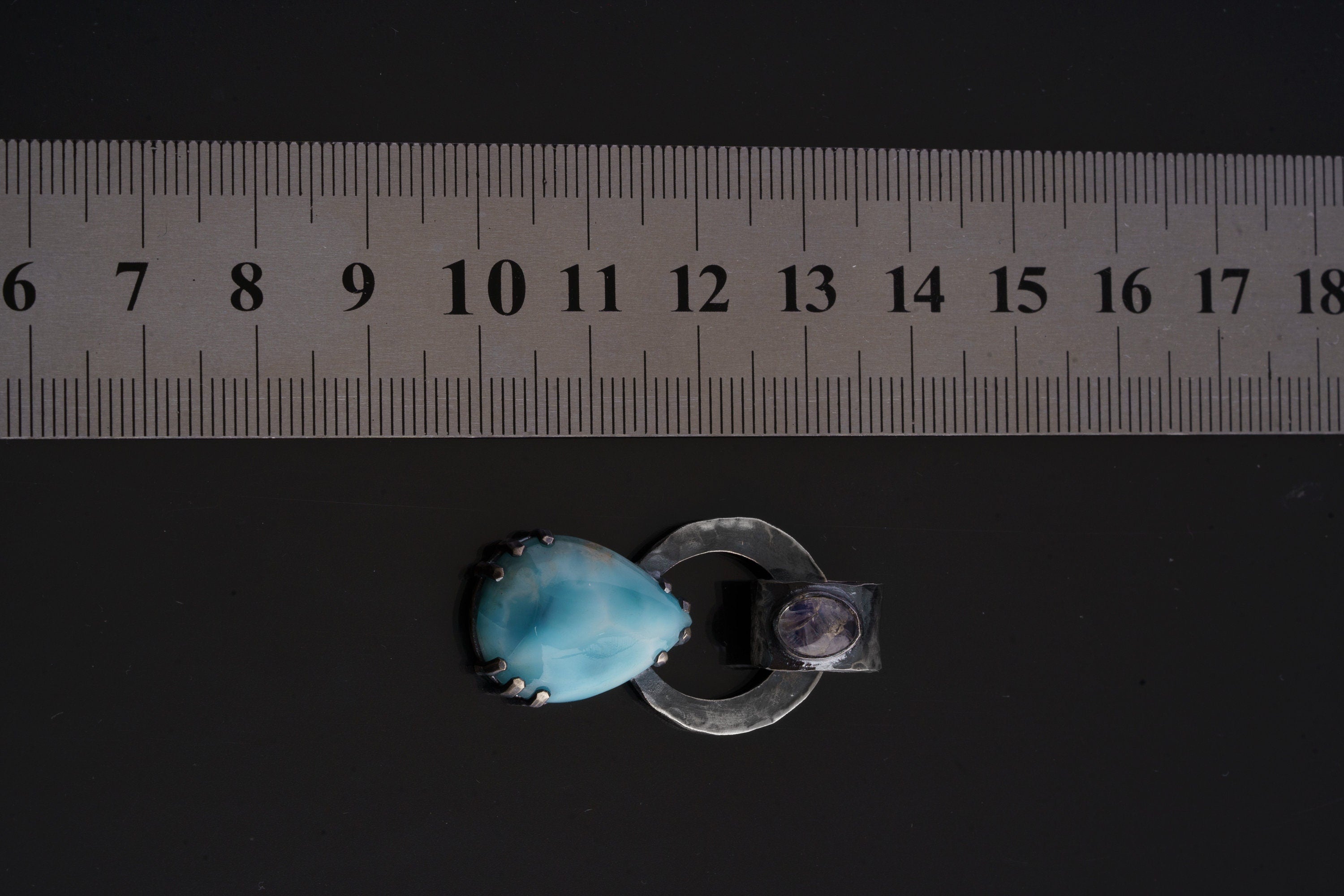 Blue Moonstone Larimar pendant shown beside ruler for scale 3cm with oxidized sterling silver claw setting.