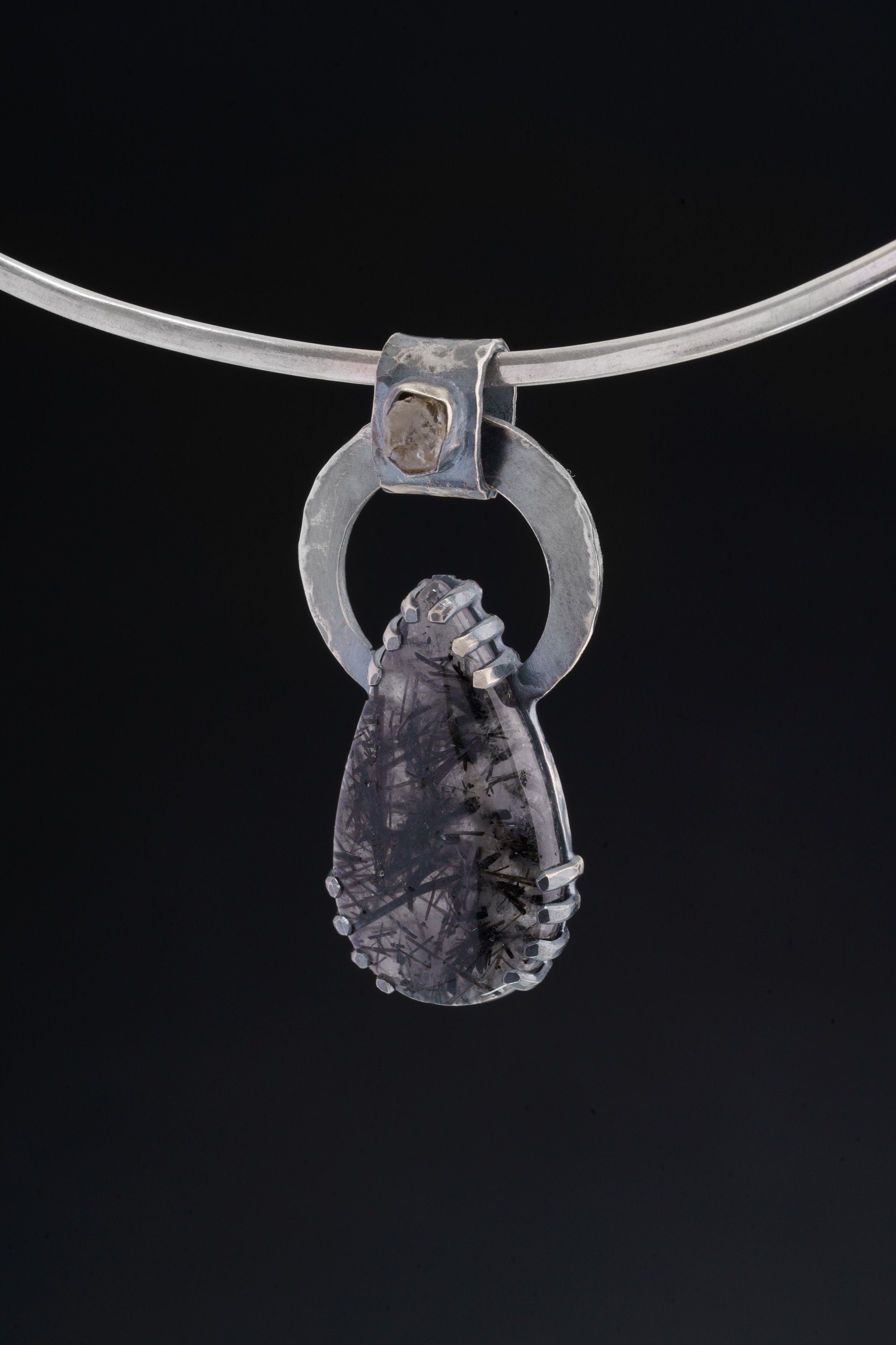 Moonstone and Black Rutile Quartz pendant displayed on silver choker against black background.