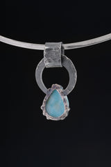 Larimar and Blue Moonstone pendant shown with silver chain, highlighting handmade oxidized silver and blue gemstone contrast.
