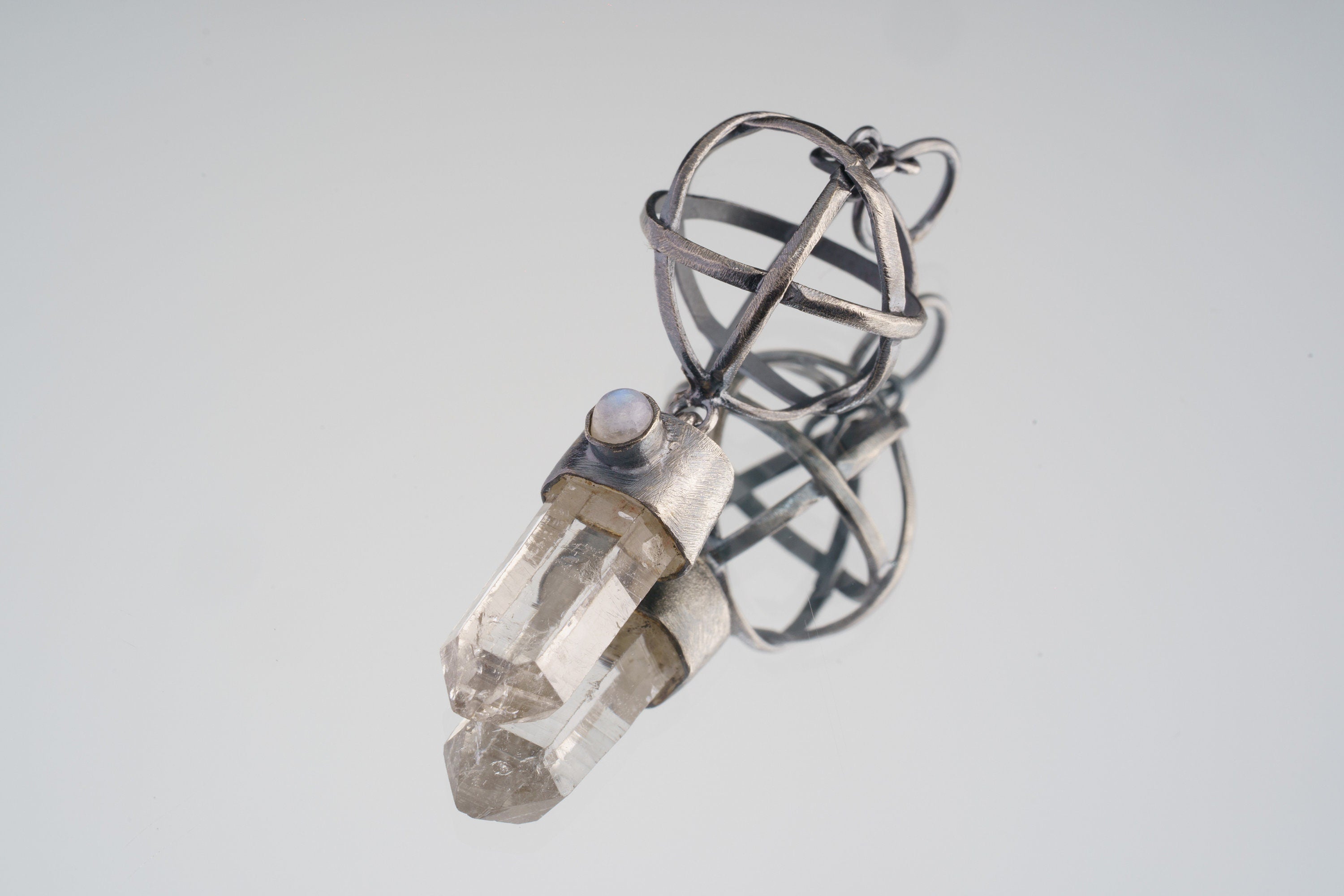 Himalayan Lemurian Quartz Moonstone pendant in oxidized 925 sterling silver, shown with long crystal point and open sphere design.