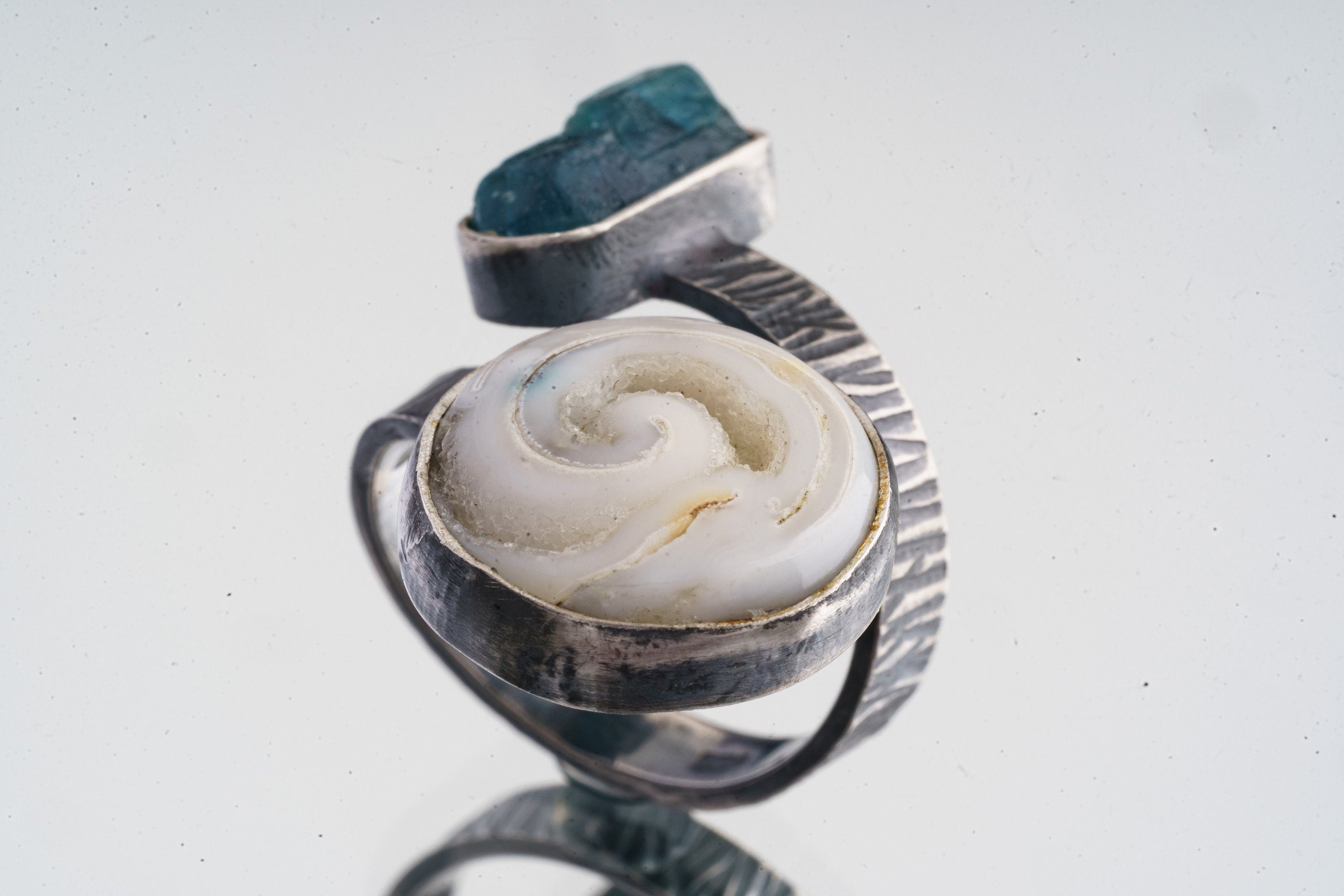 Side view of Apatite and Crystallized Shell ring showing oxidized sterling silver bezel texture and sculptural open construction.